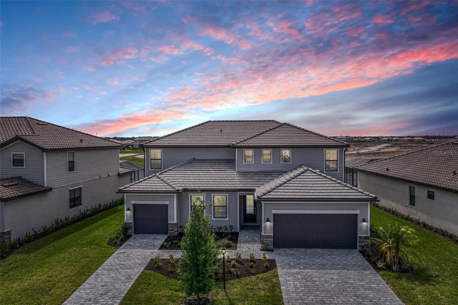 Spectacular living space, winding water views, and a prime location can be yours. Highly-desired "Liberation" floor plan. Situated on one of the best water view homesites in the popular Lorraine Lakes resort neighborhood. This beautiful home offers all the space your family desires. The acclaimed layout features 6 spacious bedrooms, including a fabulous ‘casita’ with separate entry, private garage, a dedicated living room, kitchenette, and laundry space— apart from the main home. The elegant exterior is highlighted by a paver driveway, tile roof, lush landscaping, and leaded glass entry. Stepping inside, the open and sun-washed interior benefits from a coveted Southern exposure and is light and bright throughout. An open great room is centered around a timeless kitchen with white shaker cabinets, stainless steel appliances, and creamy polished granite countertops. Up the stairs, you'll find a sizable bonus room, spacious secondary bedrooms, and a sprawling primary bedroom with large dressing room area and spa inspired bathroom with a relaxing garden tub. A neutral color palate gives you the opportunity to move right in and personalize to your taste. Outside, the heated pool and extended screen enclosed outdoor living area overlooks a sparkling water view that must be seen to be fully appreciated. Lorraine Lakes is a guard-gated neighborhood where residents enjoy wonderful amenities: a resort style pool, lap lane, toddler splash park, pickleball, tennis, indoor basketball, arcade, activity director, planned neighborhood events, fitness center, sauna and spa room, paved walking paths, fishing pier, and more. Adjacent to numerous parks, trails, the premier sports campus, the new library, and A-rated schools, you'll find this to be a prime location. Close proximity to polo fields, medical facilities, and easy access to the Sunday farmer’s market and LWR shopping and dining destinations - Main Street, On the Green, Waterside, and more. Approximately 20 minutes to UTC, 35 minutes to downtown Sarasota, 45 minutes to downtown St. Petersburg. Come see this exceptional home. Perfect for multi-generational households, remote workers, or visiting guests, this inviting home is waiting to become your family’s perfect full-time residence or sunshine retreat.