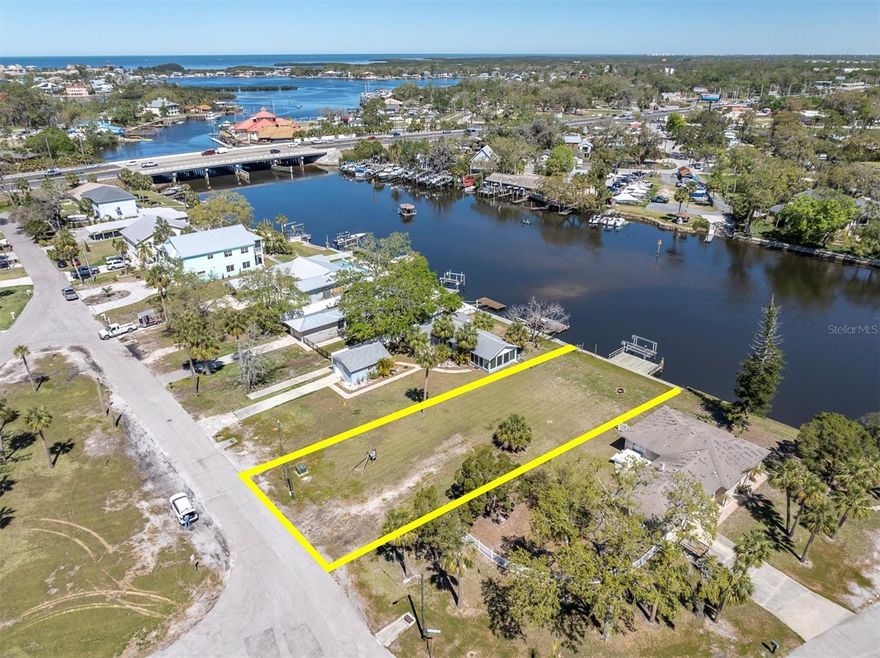 A quarter-acre cleared waterfront lot sits directly on the water with Gulf access. Sitting at a prime location, only a few-minute channel ride to the wide open Gulf and famous Gulf stilthouses, on the highly desirable Cotee River. Offering access to an extra-wide, deep channel with direct Gulf access, and is ready for its dream home to be built. NEW lift motor 6/25. 60' of waterfront! EXTRA DEEP lot at 173! The Impact fees have already been paid, ready to build! Public utilities! No HOA. No CDD.  Experience direct coastal living at its FINEST with this stunning vacant lot and dock.  Imagine enjoying views of dolphins, manatees, and saltwater fish right in your backyard! Building up will provide Gulf Views. Boat to some of the prettiest islands on the Gulf Coast, just a few minutes away. The lot features a private dock and lift, completed with electric and water. Several waterfront restaurants directly neighboring this land allow you to tie up directly at their docks, including Hooters, Catches, Whiskey Joe's, Whiskey River, Nauti Oar, Crabshack, and more! Conveniently located close to downtown New Port Richey (public dock available for tying up), this property offers a perfect blend of privacy and accessibility. Plus, with impact fees being paid, you will save significantly. This is the ideal spot to build your dream home, with all the groundwork already laid for you. Don't miss out on the opportunity to own this beautiful waterfront property! Check out the drone video: https://iframe.videodelivery.net/6451e9d0a74ac598e95b20dbe85b197d