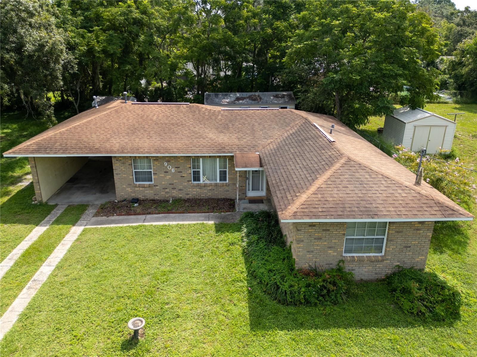 This well-maintained 1951 bungalow, built with solid block construction, offers a blend of classic design and modern updates in a Leesburg neighborhood. The 2-bedroom, 1-bathroom home features a bright living room with carpeting, connected to a functional galley kitchen with updated appliances. Both bedrooms provide ample closet space, and the bathroom includes laminate flooring for easy maintenance. A dedicated laundry room with a washer, dryer, air conditioning handler, and 2015 water heater adds convenience. Two sheds give plenty of storage or workspace, and a one-car carport provides sheltered parking. This move-in-ready home is a great opportunity for any buyer seeking quality and comfort. Schedule a showing today to see it for yourself!