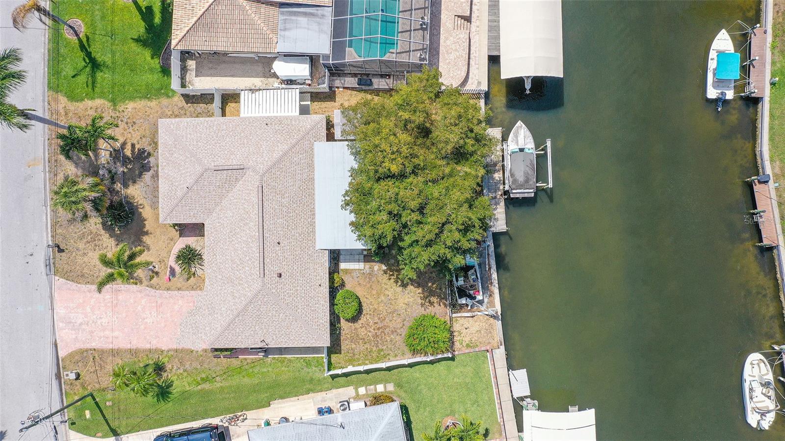 Under contract-accepting backup offers. This house is all about LOCATION, only minutes, whether by car, bicycle, or boat, to the local Bradenton beaches, shopping, restaurants and fun of Anna Maria Island, a short drive to Sarasota, close to IMG Academy and Sarasota/ Bradenton International Airport. Whether you are looking for a quick fishing trip in Sarasota Bay or a day trip on the Gulf of Mexico through Longboat Pass, you will be minutes away from your adventure as you set out for the day from your own backyard canal. This classic move in ready, Florida ranch style home is single story construction and has two bedrooms, two baths, and full views of the backyard saltwater canal in the highly desirable and sought after Coral Shores neighborhood. On the water's edge in West Bradenton, Coral Shores is all about "Florida living", with a mature and well maintained lush and tropical neighborhood of only 189 homes. The HOA is optional at $95 per year. The property features a new shingle roof installed in 2022, plenty of room to dock your boat, a shed and a fenced in side yard. There is an oversized one car garage that easily accommodates your vehicle and still has ample room for tools, beach gear and the occasional small project. The driveway offers plenty of off street parking with room for up to 4 cars. This home has great flow from the foyer entrance to the spacious great room that opens to a large Florida room leading to your beautiful backyard tropical oasis and views of the canal. This estate home is ready for your personal touch, whether it’s your year round dream home on the water, vacation home or an investor looking for an amazing property this home has it all. This home would make a fabulous rental property, as there are currently no rental restrictions in Coral Shores. Pets welcome. In- ground sprinkler system. No deed restrictions. The home is being sold as is and ready for your updates.