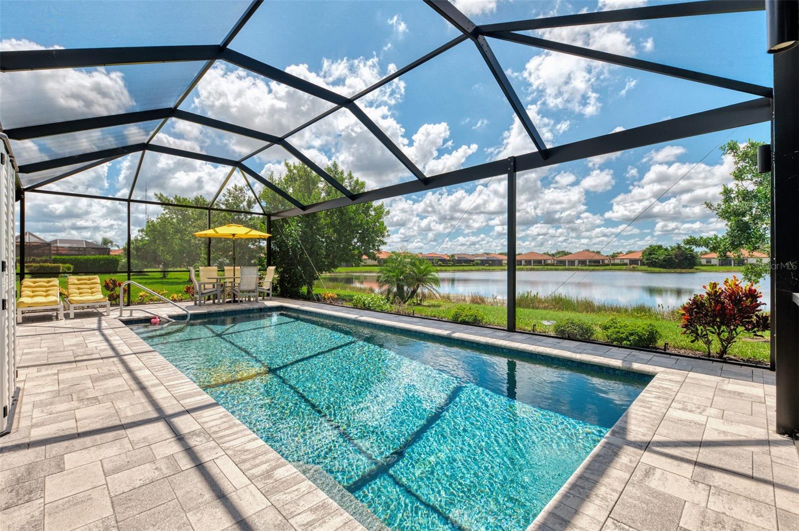 Discover this beautifully maintained and move-in-ready Pool home featuring 4 Bedrooms, 3 Bathrooms, 2025 Sq Ft in a vibrant, MAINTENANCE FREE community with LOW HOA Fees and NO CDD Fees. It’s perfectly designed for comfort, privacy, and peace of mind. Enjoy a premium lot with stunning WATER view, rich in abundant wildlife through the clear view lanai screen while relaxing in your CUSTOM SALTWATER Pool. The pool is perfect for swimming laps or unwinding in the evening with multi-hued lights that create a beautiful nighttime ambiance. For storm protection, easy close Accordion Shutters are on order for all windows, and Kevlar Hurricane Screens for the Covered Lanai area. Plus, this home is equipped with Smart Home Technology and a Whole House Water Filtration System. The split floor plan features two Bedrooms, on one side of the home which are currently used as offices with extra storage, offering versatile space to suit your needs and a Guest Bath. A second En suite Bedroom is located on the other side of the home. The Primary Suite is ideally situated for relaxation and tranquility, enhanced by two CUSTOM Walk-In Closets and a luxurious En suite with dual sinks, and Large Shower. The Great Room with triple sliders flows to the Dining area and gourmet Kitchen featuring granite countertops, stainless steel appliances, island, abundant cabinetry with crown, pots & pans drawer, and LARGE Pantry. Laundry is a breeze with a designated folding area which leads to the garage with epoxy flooring and hurricane rated garage door. Watercrest is a gated community where your HOA Fee includes your Lawn Care, Trimming of Landscaping, Irrigation, Community Pool, Fitness Center, Corn Hole and Bocce Ball. Excellent location, less than 5 miles to Downtown Venice pristine Beaches, fine Dining, Shopping, Legacy Trail and the Venice Theatre. Near grocery stores, medical offices, and Sarasota Memorial Hospital. Schedule your showing today and fall in love with your new home!