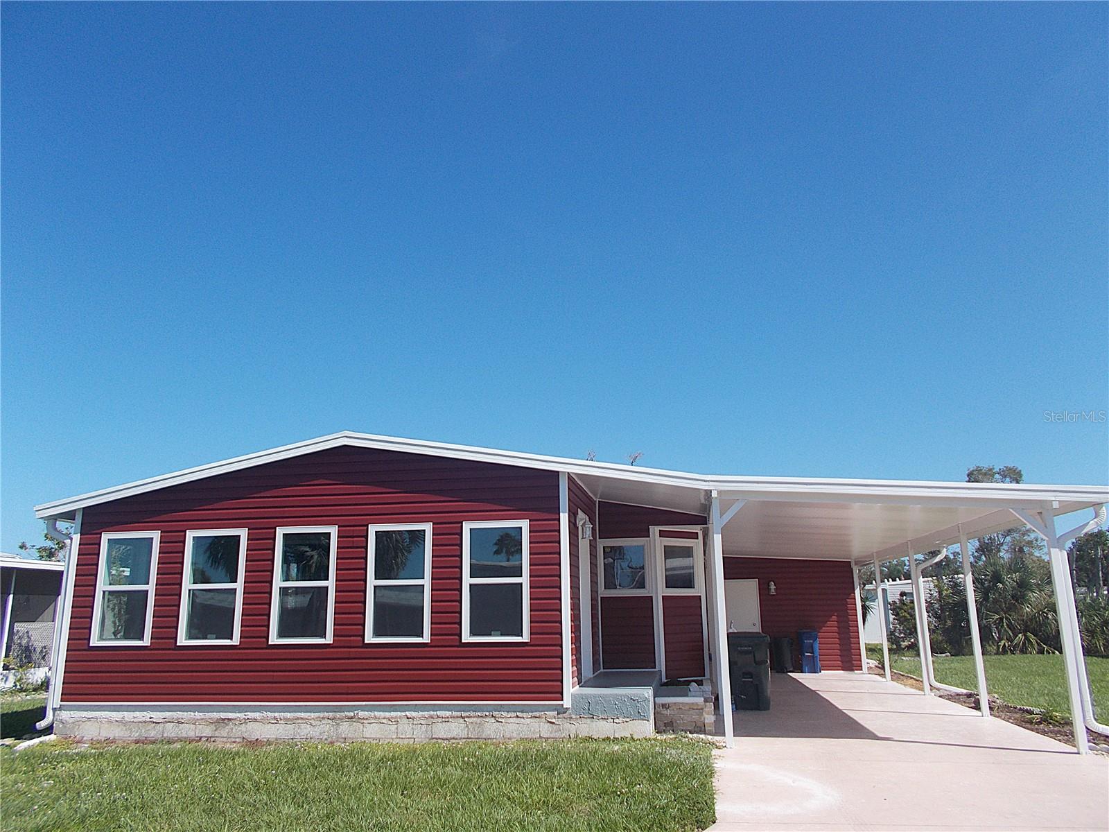 This may be a 1983 mobile, but just about EVERYTHING is BRAND SPANKING NEW!!!! This 2 bedroom, 2 bath mobile in Sandalwood Park offers over 1,000 square feet of living area PLUS a brand new 19x9 Florida room with 7 real windows!! Talk about letting the beautiful Florida sunshine in!! You will find a brand new kitchen, complete with stainless appliances (including a dishwasher), new vinyl flooring throughout, new electrical panel, new primary ensuite bathroom, new vanity in the guest bathroom, freshly painted inside, generous room sizes AND inside laundry! Outside you'll enjoy a new roof with a transferrable warranty, new carport, new vinyl siding and a brand new shed. Sandalwood Park offers a heated & cooled pool, tons of activities & gatherings, a dog park and the location is superb! You're close to shopping, medical offices, restaurants and just about everything you need! Don't miss out on this fantastic opportunity in one of Venice's most sought after parks. Make your appointment today and make this mobile yours. . . . . before someone else does!