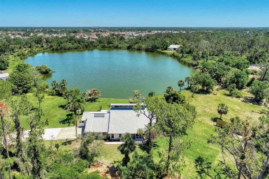 Your Dream Home Awaits — Just One Mile from Manasota Beach
Waterfront-1.23 Acre one-owner Estate. Imagine waking up every day knowing the beach is minutes away and home feels like a private retreat. This elegantly inspired, beautifully built residence is designed to capture your heart from the moment you arrive. A Private Waterfront Escape-Set along a serene private lake, this meticulously crafted pool home offers peace, privacy, and everyday tranquility. With three separate suites, everyone enjoys their own personal sanctuary—perfect for family living or hosting guests in comfort. Storybook Views, Everyday Magic-Wake up to lake views that feel straight out of a fairytale. Pride of ownership shines at every turn, from the winding private driveway to the lush, manicured gardens that frame the home beautifully. Suite Dreams, Elevated-The upper primary suite is a true showstopper—an expansive BONUS retreat featuring sliders that open to a private upper deck with fireplace. It’s ideal for morning coffee, evening sunsets. A second primary suite on the lower level and a private guest suite add flexibility and comfort for any lifestyle. Where Culinary Magic Happens-Calling all chefs! The gourmet kitchen is designed to impress with custom cabinetry, granite countertops, double ovens, a center island, and a spacious breakfast bar. Whether entertaining or enjoying a quiet night in, this kitchen is ready to deliver. Coastal Living at Its Best-Enjoy the best of both worlds—peaceful living without giving up convenience. Located approximately one mile from the Gulf of Mexico, you’ll have easy access to world-class fishing, boating, swimming, sunbathing, and a vibrant coastal lifestyle. Motivated Seller • Easy Closing-the path to closing is smooth. This dream home is ready for its next chapter—and it could be yours.  Ready to experience the heart and soul of this extraordinary property? New 2 story Pool Cage 2026; New Roof 2020, Home painted 2021, Pool Pump replaced 2022; Solar Panels replaced 2022; Septic Pumped 2022; Garage door opener 2023; Central Vac 2023; AC’s 2010 & 2011;  Home has several hurricane sliders, upstairs Bedroom Hurricane windows. Please Schedule your private showing today and let the magic begin.