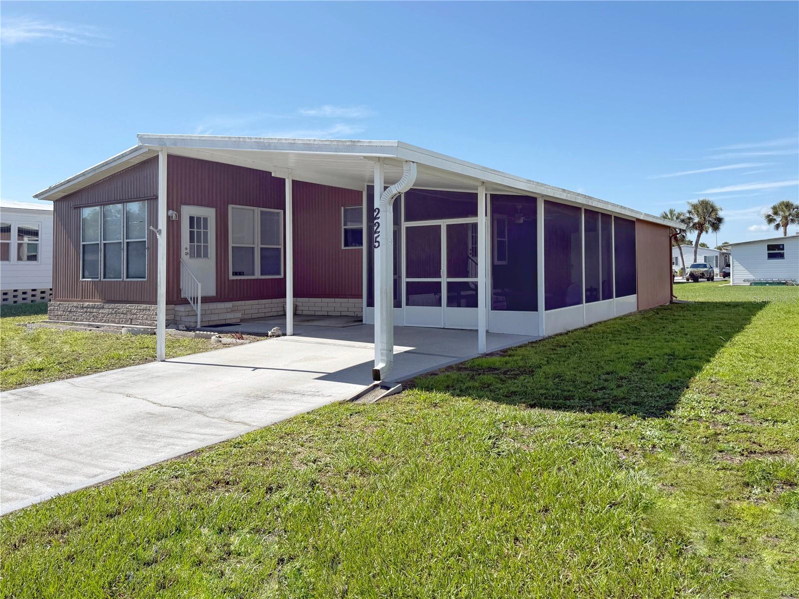 This very affordable two-bedroom, two-bathroom home is nestled in the vibrant community of Caribbean Isles Residential Cooperative, yet offers a peaceful and private retreat. With no LOT RENT or CDD you can enjoy the benefits of homeownership with a low monthly maintenance fee, making this property an excellent value. The primary bedroom offers an ENSUITE bathroom, with a second bathroom off the hall for guests. Sliding glass doors off the living room lead into a fully enclosed SUNPORCH, which can be used for year around relaxation as a den, as office space, or even as another sleeping space for overflow guests. The home comes partially furnished, too! Outside the kitchen door is a screened-in LANAI, ready for your morning coffee, lunch, or end of the day glass of wine. Here you can enjoy the beautiful Florida weather, waving to your new friends as they pass by on their golf carts, bikes, or walking with their pets. With four miles of private roads, you can walk to the clubhouse, pool, lagoon park - or visit with your friends and neighbors - while getting in all of the exercise you want. Caribbean Isles is a 55+ waterfront community filled with amenities designed to enhance your lifestyle. Residents can take advantage of a clubhouse that hosts social events and activities, a HEATED POOL perfect for year-round relaxation, and a private boat and kayak launch with direct access to Tampa Bay—an ideal setup for boating enthusiasts. Other features include shuffleboard courts, a dog park, RV/boat storage, bocce ball, and a full calendar of community events that foster camaraderie among neighbors. Located in the heart of Apollo Beach, this property offers convenient access to shopping, dining, and entertainment options, as well as nearby parks and beaches for outdoor recreation. The area’s major highways make traveling to Tampa, St. Petersburg, and Sarasota effortless. Don’t miss the opportunity to own this AFFORDABLE HOME in one of Florida's premier 55+ communities.