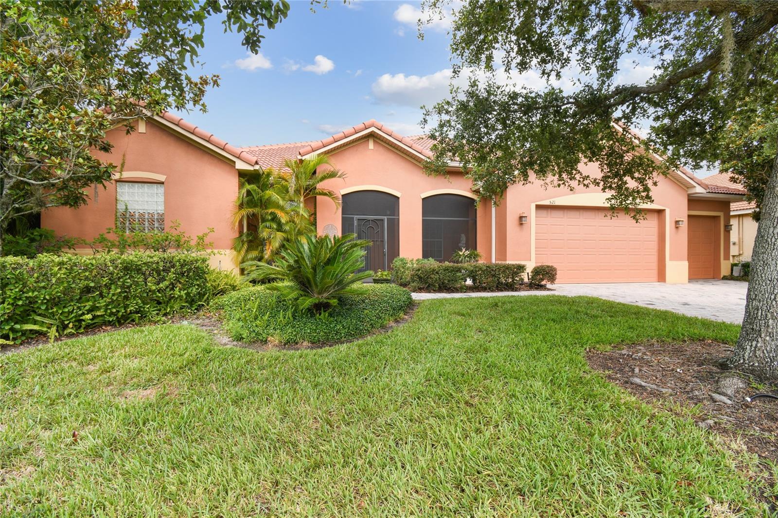 One or more photo(s) has been virtually staged. Welcome to this truly amazing and spacious 3-bedroom, 3.5-bath Operetta model with a DEN and rare THIRD-CAR GARAGE, nestled on an oversized, beautifully landscaped lot with lush WATER VIEWS and a FENCED yard for added privacy. NEW BARREL TILE ROOF installed in 2023, offering peace of mind and long-lasting durability! NEW HVAC 2024. NEW HWH 2024. Enjoy high ceilings, a bright living and dining area, and a large kitchen with 42-inch cabinets, LOWER pull-outs, closet pantry and a breakfast bar that opens to the Florida room and lanai—perfect for indoor-outdoor entertaining. The PRIMARY SUITE offers lanai access, TWO walk-in closets, and an ENSUITE BATH with DUAL SINKS, a DOORLESS SHOWER, and a makeup vanity. Two guest bedrooms and a full bath are tucked away for added privacy, and the front-facing den with golf course views makes a great spot for an office or hobby space. One of the bedrooms even has a MURPHY BED perfect for saving space when it’s not in use. Step outside and enjoy tranquil WATER VIEWS from your private backyard, lined with trees for added seclusion. A SIDE PATIO is perfect for grilling, and the EXTENDED covered lanai offers the ideal space to unwind. This home blends comfort, space, and scenic views—perfect for relaxing or hosting. Spacious 3-car garage features a workbench for hobbies, pull-down attic stairs, utility sink, and a NEW GARAGE DOOR MOTOR (2023). The home comes equipped with ALUMINUM HURRICANE SHUTTERS, offering peace of mind and added protection. Solivita offers incredible resort-style amenities including 36 holes of championship golf, 14 heated pools, 17 pickleball courts, 9 tennis courts, 2 fitness centers, 3 restaurants, and over 250 resident clubs. Enjoy a softball field, bocce, shuffleboard, billiards, dog parks, walking/biking trails, and more. The HOA covers landscaping, irrigation, road maintenance, 24/7 gated security, and includes fiber optic internet and TV service. ***Poinciana Lakes Plaza is a MAJOR NEW SHOPPING CENTER that opened directly across from the Solivita Main Gate in Summer of 2024. It features Sprouts Grocery, TJ MAXX, Ross, Burlington, Rack Room Shoes, 5 Below, Ulta, Outback, First Watch, 5 Guys, Urgent Care, Dentist, TD Bank, Petco & Hair Cuttery PLUS MORE TO COME.***