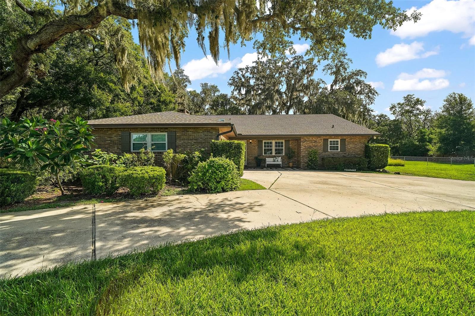 One or more photo(s) has been virtually staged. UNBEATABLE NEW PRICE! Your chance to own a piece of the country while enjoying the convenience of city life and TOP-RATED SCHOOLS.
Welcome to your dream Equestrian Estate in sought-after Wolf Branch Estates—a horse-friendly community where wide-open spaces and majestic oaks meet modern comforts. Nestled on 2.5+ picturesque acres, this property is perfect for horse lovers, multi-generational families, or anyone seeking room to breathe and a slower pace without sacrificing access to everyday amenities. The main home offers a flexible split floor plan with 4 bedrooms, 3.5 full baths, and 2 master suites. A wide foyer leads you into the spacious living areas, including a large family room with a cozy wood-burning fireplace and a Florida room that opens to a backyard oasis. The kitchen is a true heart of the home—featuring a central island, abundant cabinetry, and plenty of space for entertaining. The second dwelling—a versatile 1,440 sq. ft. space—includes a fifth bedroom (in-law quarters), full bath, walk-in closet, bonus room, and garage. It’s ideal for guests, extended family, a home office, or a creative studio.Outdoors, the property shines with its park-like setting, four-rail fencing with goat wire, and ample room for horses to roam. Picture weekend BBQs under the pergola beside the custom rock fireplace, kids playing on the commercial-grade playground, or evenings watching the sunset from your back porch. This property comes exceptionally equipped with numerous updates:
? New roofs on both buildings (2024)? New septic tank drain field (2025)? New tinted skylights & wood trim (2024)? Well pressure tank (2025) & hot water heater (2023)? Double-hung low-E windows with lifetime warranty (2018)? Blown-in attic insulation (2022)? Re-plumbed (2019)? Four-rail fencing with custom aluminum gates (2019)? RV 240-amp outlet, generator hookup, and active termite bond? Concrete patio with pergola & fireplace (2022)? Commercial playground (2018) and flagpole (2023).A back-gate entrance makes it easy to bring in equipment, trailers, or guests to the secondary dwelling.This is more than a home—it’s a lifestyle. Whether you’re a homeschooling family, small business owner, remote worker, or equestrian enthusiast, this property offers the freedom to live, work, and play all in one place.All of this is tucked away in tranquil Sorrento, yet only minutes from Mount Dora, the 429, and an easy drive to Orlando’s shopping, dining, and airports. Country charm. City convenience. Space to live your dream. SELLER MOTIVATED—will consider alternatie ways of ownership: lease option, lease to own, seller financing with acceptable terms-now is your time!