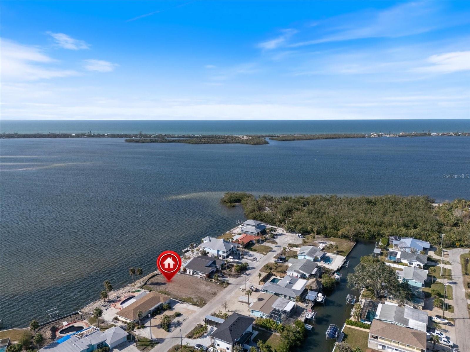 Incredible waterfront property tucked in an alcove on Lemon Bay just off the Intracoastal Waterway & steps away from the 210-acre Lemon Bay Park. Shovel ready with Impact fees paid! Sewer & water lines are in place capped off, just need to connect to them. Build will be in AE Flood Zone so ONLY STEM WALL NEEDED, no pilings which is an enormous money saver. Neighbor next-door is for sale as well so DOUBLE LOT is possible! Plenty of room for a pool. Seawall was replaced in 2008 retaining its grandfathered loading step for easy use in endless kayaking & fishing opportunities off the backyard, along with a plethora of wildlife to enjoy. A pod of dolphins visits daily, with Egrets & Herons hanging out on the seawall, young tarpon playing & mullet jumping daily. Blind Pass Beach is just across the Intracoastal. View is priceless! This gem surrounded by beaches, boating, golfing, shopping, restaurants, historic Dearborn Street, and so many more amenities that attract the world to vacation here! Have floor plans & quotes for a 2100 sq.ft. 3 bedroom, 3 bathroom, with an office from a local builder, ask for more details.