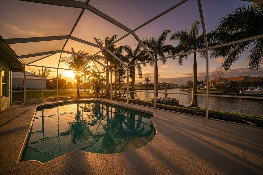 Enjoy BEAUTIFUL SUNSET VIEWS and QUICK GULF/WATER ACCESS from a very well maintained WATERFRONT POOL HOME located in the highly sought after community of South Gulf Cove. This sprawling oasis features 3 bedrooms and 3 bathrooms along with a space that can be used as a den/office or even a formal dining room. The home is positioned on a peaceful west facing canal. The details in this house will catch your eyes immediately boasting CUSTOM WAINSCOTING AND CROWN MOLDINGS throughout the home. You'll enjoy a space that feels very airy featuring tall tray ceilings upon entering through FRENCH DOORS with instant water views. This home is outfitted with IMPACT WINDOWS and DOORS for your protection and convenience so you won't have to worry about hurricanes. This SPLIT FLOOR-PLAN offers privacy for you and your guests and every bedroom has access to their own bathroom. The heart of this house is the GOURMET KITCHEN featuring GRANITE COUNTER TOPS, NEW STAINLESS STEEL APPLIANCES, CUSTOM CABINETRY, UNDER CABINET LIGHTING, TWO LARGE PANTRIES and PULL OUT SHELVES. In the kitchen-area and family room you'll notice several CUSTOM MADE SHELVES that provide storage and gorgeous display areas, as well as extra electrical outlets for your convenience. The family room is very spacious offering water views, and even comes with a BUILT IN MOVIE SCREEN AND PROJECTOR. Why go to the movie theater when you have one at home? The dinette between the kitchen and family room is equipped with semi-aquarium windows offering amazing views to enjoy with your meals. The primary bedroom is HUGE in this home and has a slider directly to the pool area as well as a large walk-in closet with enough space for all the clothes you could ever dream of. The primary bathroom boasts double vanity sinks, soaking tub and a large walk-in shower, as well as a water closet and linen closet. The laundry room in this home has space like you would not believe. The shelving nearly goes all the way up the tall ceilings, which is a feature that you don't truly appreciate until you have it at your disposal! The pool area is very tranquil featuring plenty of room to lounge and relax with a view. The seawall is already in place and ready for you to install the dock and boat lift of your dreams. The water access from this home is truly remarkable giving you the ability to reach nearly anywhere including but not limited to the Charlotte Harbor, Gulf of Mexico/America, Myakka River, Intercoastal Waterway as well as all the waterfront restaurants you'll find a long the way. The location of this property puts you in close proximity to the famous beaches of BOCA GRANDE, ENGLEWOOD and MANASOTA KEY. You'll also enjoy a short drive to multiple Spring Training Baseball Stadiums, grocery stores, medical offices, Englewood Hospital, fantastic restauraunts and pro level golf courses. South Gulf Cove is highly sought after and features an OPTIONAL HOA giving access to a Clubhouse and Boat Ramp. South Gulf Cove features Parks, Plagrounds, Farmers Markets, Pickleball Courts and MORE. Once you experience what this area has to offer, you'll realize why so many people come to Florida as part time residents and become FULL TIME RESIDENTS. This home is not a home you will want to miss. Call your agent and book your showing! BE SURE TO CHECK OUT THE 3D VIRTUAL TOUR ON ZILLOW.