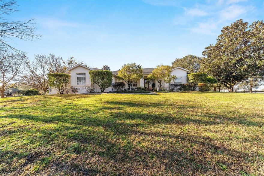 Nested among 25 acres of pristine countryside, this exceptional equestrian property offers everything the dedicated horse enthusiast could desire. The thoughtfully designed facility seamlessly blends luxury living with professional equestrian amenities, creating the perfect harmony of comfort and functionality. A total of 10 paddocks are in place, each featuring gentle shade from mature trees and automatic waterer for added ease of care. An additional round pen is also established, adding additional options for training. Two barns, both of which offers a concrete block construction and center aisle design, offers a combined total of 30 stalls with a feed room, tack room, fly spray system, and a large, covered wash rack area with multiple spaces. Both barns come with their own private barn apartments, which provide additional options for farm managers or seasonal rental opportunities. A larger two-story barn apartment is attached to the larger barn and includes a full kitchen, a large living/dining room combo, and upper loft with a large bedroom, full bathroom, and private balcony. The smaller barn includes an apartment with multiple bedrooms and a fully equipped eat-in kitchen, living room, and potential office space. For additional guest options, the property also features RV hookup and storage space. Surrounded by tasteful landscaping towards the back of the property is the main residence, which offers a total of 3-bedrooms and 2-baths and totals over 2,500 sq.ft. of space. Light and bright, the home features large windows to take advantage of the surrounding views, cathedral ceilings, and tile flooring throughout the main spaces. The kitchen is well appointed with ample cabinet and granite countertop, stainless steel appliances, additional pantry, and breakfast bar. The living room is incredibly inviting and spacious, directly open to the Florida Room which offers direct access to the pool area. While all bedrooms are comfortable, the primary suite is especially notable with a large layout, private access to the pool, two large walk-in closets, and a private en-suite with glass-door shower, garden tub, and dual vanities. Those who enjoy hosting will love the screen-enclosed pool area, which features an expansive pool deck with covered area for seating and gorgeous views of the back portion of the farm. This unique farm has a convenient location near US Route 301 and 441, making it a breeze to explore either Ocala or Gainesville. Don't miss this incredible opportunity to live your dream