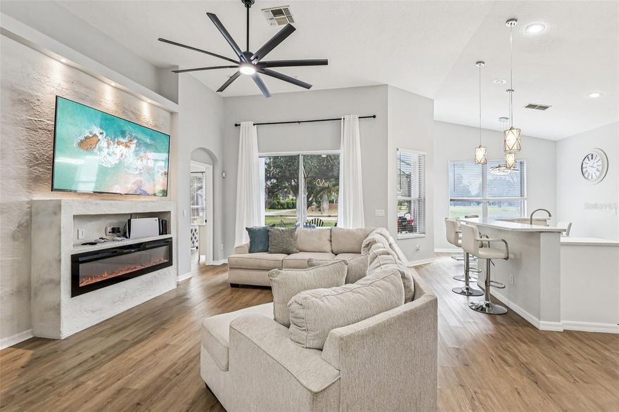 Welcome to 211 Westmoreland Circle in the renowned Remington development of Kissimmee, Florida—where elegance and convenience come together in perfect harmony!

Step inside this stunning single-family home and be greeted by an open floor plan with soaring cathedral ceilings and elegant laminated floors throughout. The foyer welcomes you with a stylish epoxy floor, setting the tone for the modern elegance found throughout the home.

At the heart of the house, you'll find an updated gourmet kitchen featuring a thoughtful design layout, quartz countertops, stainless steel appliances, and a brand-new dishwasher to make hosting a delight. Gather around the linear fireplace in the living area for cozy evenings at home.

The main bedroom offers a private retreat with its own en-suite bath, while the additional three bedrooms are perfectly arranged: two in a convenient Jack-and-Jill style with a pocket door, and another on the opposite side of the home for extra flexibility—ideal for guests or a home office.

Enjoy the private screened patio for morning coffee or evening relaxation, and take advantage of the two-car garage for easy parking. With high-efficiency central air, ceiling fans, and a top-tier home security system, your comfort is guaranteed.

Nestled amid beautiful golf course landscapes, with quick access to retail, the airport, and Disney, this Remington gem is ready to welcome you home!