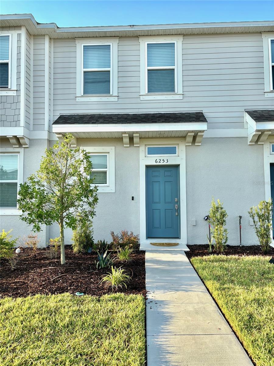Welcome to Edgestone at Artisan Lakes, where exceptional value meets modern living in this beautifully designed 2-bedroom, 2.5-bathroom townhome. Step inside through a long, inviting foyer that sets a warm and elegant tone for the entire home. The stylish open-concept kitchen offers ample cabinetry and a stunning backsplash, overlooking the combined dining and gathering areas, perfect for entertaining or relaxing with loved ones. The spacious gathering room, the heart of the home, flows seamlessly to the screened covered lanai for enjoyable indoor-outdoor living. A thoughtfully located half bath on the main level adds convenience for you and your guests. Upstairs, find two generously sized bedrooms, each with a private en-suite bathroom and walk-in closet, including a master bedroom that offers a serene lake view. The centrally located laundry area adds ease and efficiency. Residents will appreciate the convenient proximity to the community clubhouse, featuring a resort-style pool and grill area for relaxation and entertaining, while enjoying the peace and quiet of a location set away from any noise.