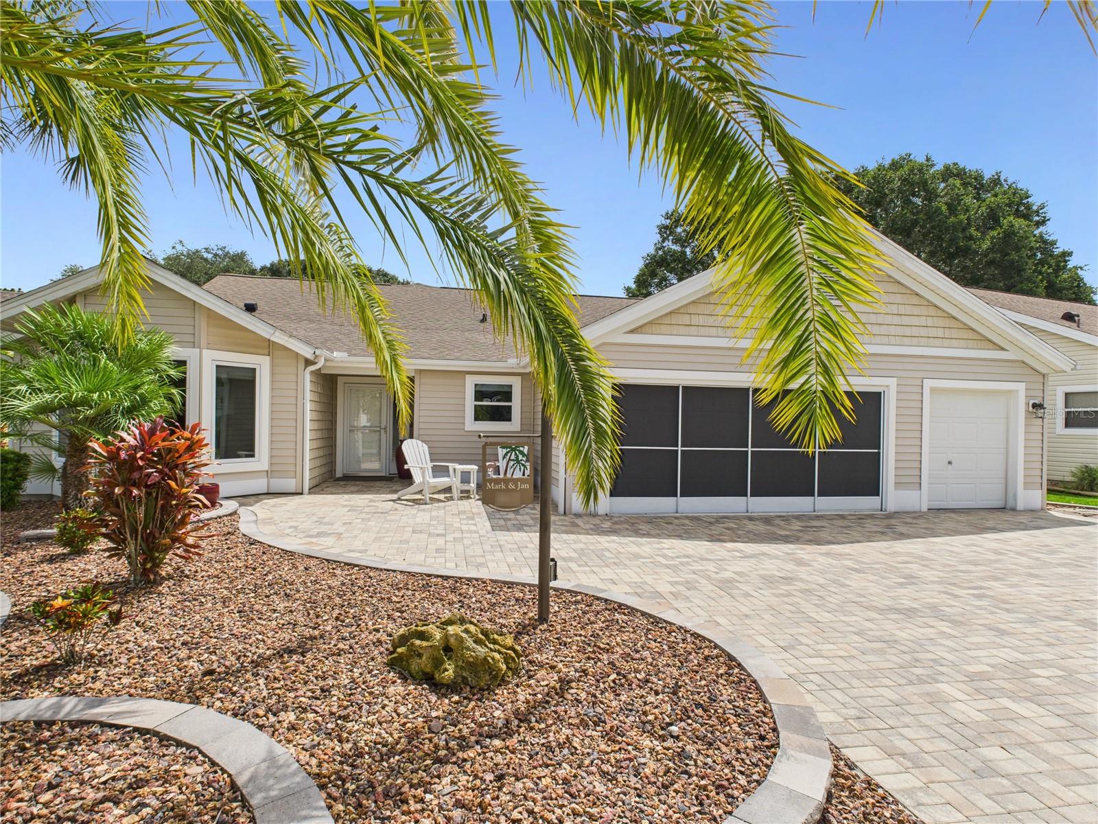 Remodeled and Redesigned Cypress with superb updates and upgrades throughout the interior and exterior. This is the dream home you have been waiting for between Spanish Springs Town Square and Lake Sumter Landing. Near an abundance of shopping, restaurants, pools, recreation centers, golf courses, pickleball courts, churches, hospital and more! From the curb you see the mature landscaping and the expansive paver driveway and walkway to the front door. Stepping inside your eyes are immediately drawn to the beautiful and serene golf course view of the full #7 fairway of the Hacienda Lakes Course through the extra height 4 panel stacking sliding glass door. A view you can't resist! Progressing past the entryway, you are greeted by the spacious living room with dry bar hosting 2-drawer refrigerator, pull-out shelves in the cabinets, storage for all your glasses and beverage accessories. To the left is recently redesigned and remodeled eat-in kitchen with all Pull out drawers and soft close doors as well as LED lighted cabinets. An incredible kitchen island, top-tier appliances including Electrolux Icon 32' Freezer and 32” Refrigerator w/custom double vent, GE Monogram Cafe' doors convection oven and GE Monogram induction cooktop with Wolf power ventilator/light. The kitchen island countertop is custom powder coated metal from Arkansas and hosts an abundance of storage with pull out drawers. There is a separate coffee bar with water hook-up for your convenience. Entering the Primary bedroom enjoy 10 ft high closet storage with double hanging and additional shelves for storage. The Primary bathroom has double sinks with storage tower between them. Custom large glass enclosure shower. Enjoy the privacy of a split floor plan with the guest bedrooms across the living room. Guest bedroom 1 has a closet. Guest bedroom 2 has a space for a closet or could be converted into a large work space w plantation shutters. The oversized interior laundry room has plenty of space for storage and large laundry sink. The garage is an extra deep 2 car garage with an additional 3rd stall golf cart garage/shop space. Want outdoor living? How about outdoor living with Twin Eagles grilling station and soft close stainless steel cabinets, Twin Eagles ceiling mounted electric radiant heaters for the cool nights, additional power sunscreens over the entire lanai. Visitors will enjoy the putting green and outdoor patio space or just relaxing with their favorite beverage while watching the golfers on the green. Stunning sunrise view with a variety of pine, palm, and oak trees. Close proximity to the multi modal path available on the other side of the golf course. Click on the virtual tour link for a walk through look.