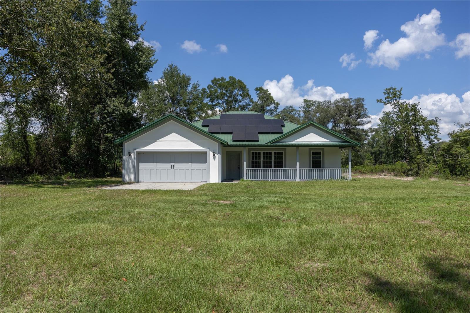 Bring your horses and enjoy country living at its finest! This beautiful and secluded 10-acre property in Fort White is mostly wooded yet thoughtfully cleared in key areas, offering the perfect blend of privacy and functionality. Already set up for horses, the property includes two paddocks, a 24' x 36' pole barn, horse pens, shelters, and a huge metal carport ideal for storing your horse trailer, truck, or farm equipment. The home has been freshly painted inside and out, giving it a bright and welcoming feel. Energy efficiency takes center stage with a 10.23 kW solar system featuring solar panels, a new 80-gallon high-efficiency water heater equipped with a heat pump, and a newer washer and dryer included. Utility bills stay remarkably low, making this home both modern and budget-friendly.Inside, you’ll find an open floor plan with brand-new carpet in the living room and primary bedroom, granite countertops, abundant soft-close cabinetry, and recessed lighting throughout. A new dishwasher adds even more convenience. The spacious master suite boasts a walk-in closet and a luxury bath with a jetted tub, dual-head walk-in shower with bench seating, creating your own private retreat. Enjoy evenings on the front porch watching wildlife, or retreat to the screened back porch overlooking a freshly cleared section perfect for a flower or vegetable garden. All of this is just minutes away from the famous Ichetucknee Springs and Santa Fe River, where you can enjoy Florida’s natural beauty. With modern updates, energy savings, and fully equipped horse facilities, this property is truly move-in ready and waiting for you.