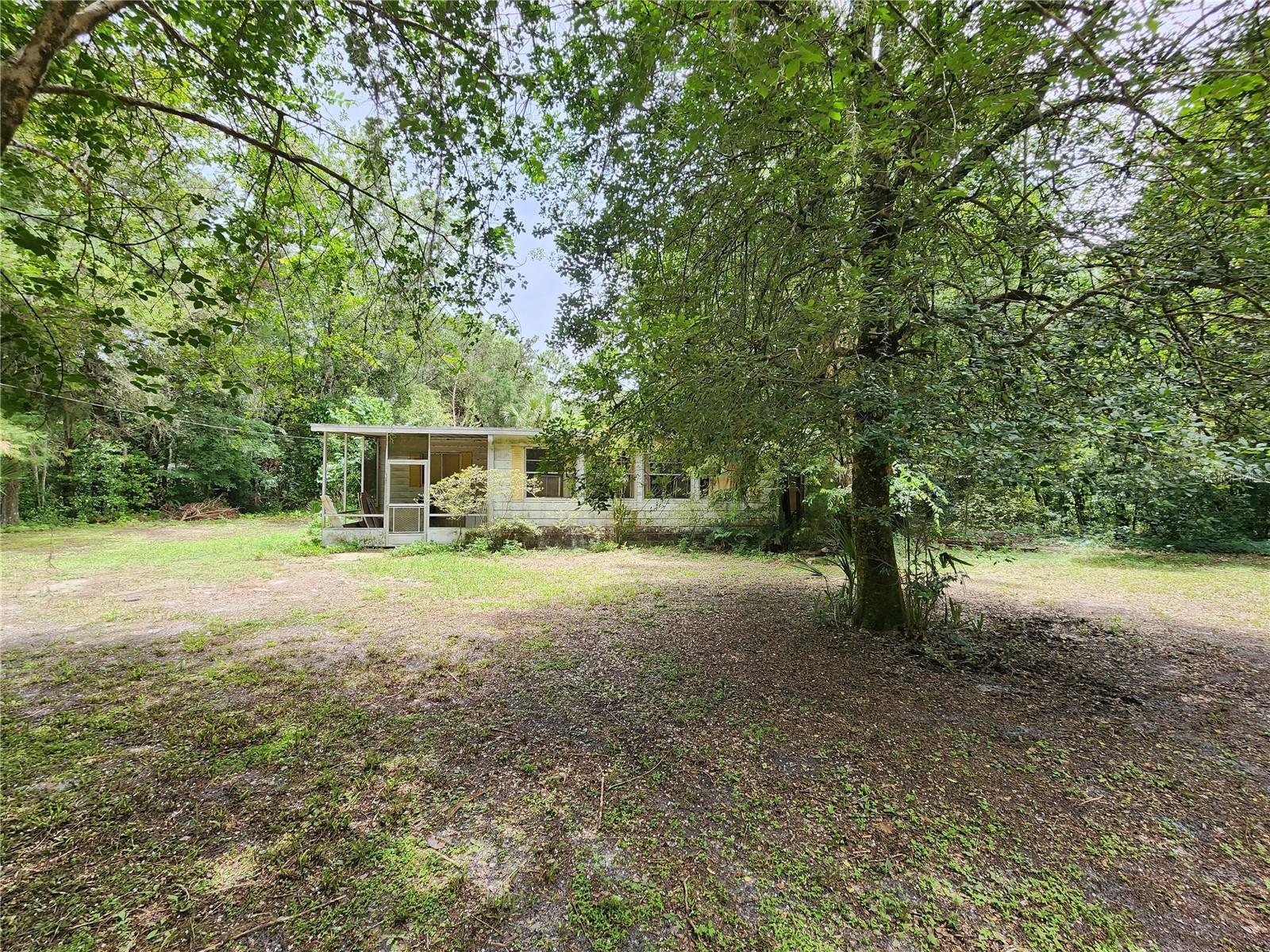 This property is located in Wekiva River Acres. A Non HOA community. The mobile home located on the 1.1 acres is in major disrepair and most likely need to be removed at the buyers discretion. This property boast gorgeous Magnolia tress, huge Oak trees, crepe myrtle, azaleas and Cypress. Nice private lot with access to the Wekiva River with optional membership to the
local property owners association. The 3.5 acre gated community park offers a boat ramp, picnic tables, a large pavilion for birthday parties etc. Wekiva Falls is located less than a 1/4 mile away. Convenient access to 429, 417 and I-4 easily connect you to all of Orlando's local attractions including Disney World and Universal Studios. Numerous sparkling fresh water springs and world famous beaches are just a short drive away. In addition Historic Mount Dora and well known Rennigers Antique Mall and Flea Market are within 30 minute drive. There is always something fun and exciting to do nearby.