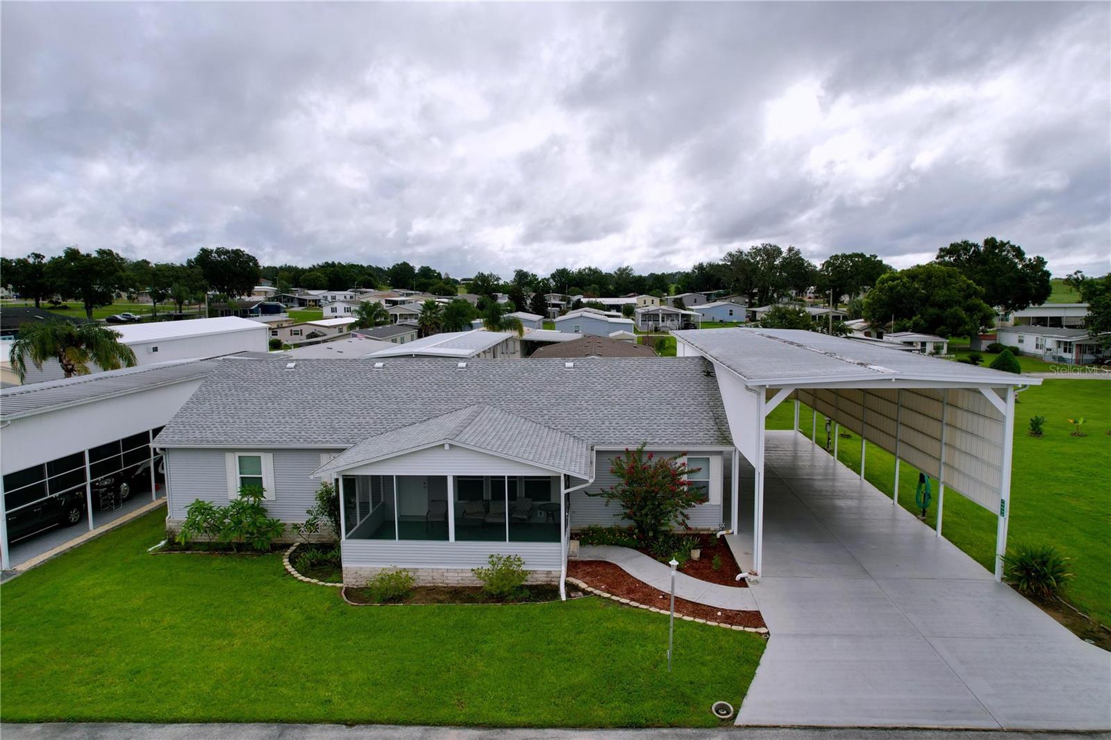 Spacious 3 Bedroom Home with Double Lot & RV Slip in Palm Manor 55+ Community. Welcome to Palm Manor, a vibrant 55+ community where comfort meets convenience. This 2004 Palm Harbor manufactured home offers 1,793 sq. ft. of living space with 3 bedrooms, 2 baths, and sits on a rare .34-acre double lot. The adjoining lot (65’x90’) comes with its own water and sewer hook-ups, providing endless possibilities. One of the standout features is the massive covered RV slip, measuring 66' long x 20' wide x 17' high and equipped with 50/30 amp power, water, and sewer hook-ups—perfect for full-time RV living or accommodating guests. Just behind the RV pad, you’ll also find a 20’x15’ storage shed, offering plenty of space for tools, hobbies, or additional storage. At the front of the home, a large screened-in porch creates the ideal spot to relax, enjoy morning coffee, or unwind with friends while taking in the Florida lifestyle. Inside, the home is pet- and smoke-free, clean, and move-in ready. The spacious living and dining rooms feature new laminate flooring, while the large kitchen includes an island, wet bar, and stainless steel KitchenAid appliances.
The primary suite is a true retreat with a huge walk-in closet and a luxurious en suite bath, complete with double vanities, a makeup station, soaking tub, and walk-in shower. On the opposite side of the home, two additional bedrooms each have walk-in closets for privacy and convenience. Additional highlights include: Large laundry room with high-efficiency front-load washer & dryer, utility sink, and extra storage, new roof, newer HVAC, water heater, irrigation system, comfort-height toilets, attic fan, and whole-house gutters. Mature banana trees adding tropical charm. Community amenities include bingo, potlucks, and entertainment, plus a heated pool, bocce ball, pickleball, shuffleboard, golf driving net, and cozy firepits. With a community well and septic, you’ll also enjoy no water bill. Perfectly located between Dade City and Zephyrhills, this home offers space, comfort, and a lifestyle you’ll love. Don’t miss out—schedule your showing today!