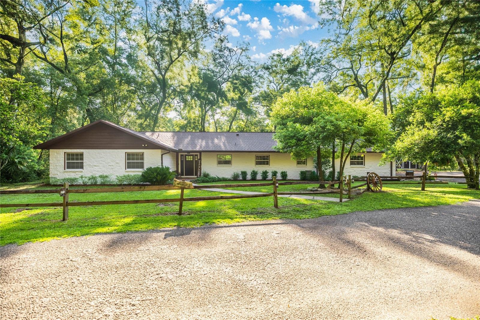 Completely Renovated Home on 11 Private Acres – Minutes from Downtown Ocala This beautifully renovated 4 bedroom, 3 bathroom home sits on 11 secluded acres, just minutes from the heart of Ocala. No detail was overlooked in the transformation of this property—inside and out. The home features all new flooring throughout, a cozy fireplace, and solid wood doors in every room. The custom kitchen is brand new, offering high-end finishes, custom cabinetry, and modern appliances. All bathrooms have been fully updated with fresh, stylish designs. Major upgrades include spray foam insulation throughout, a brand new zoned HVAC system with four individual zones, and new ductwork. All windows and exterior doors have also been replaced for energy efficiency and peace of mind. A Generac whole-home backup generator with a 500-gallon tank adds extra security in any weather. The roof was replaced in 2021. Outside, a 42x30 metal RV shop comes equipped with a 50-amp hookup, water, and sewer. The guest house/mother-in-law suite features 1 bedroom, 1 bathroom, 600 sq ft of living space, plus a 250 sq ft upstairs loft—perfect for visitors. You’ll also find a covered pole barn, equipment barn with attached chicken coop, a storage shed, and a custom-built playground for the kids to enjoy. With a 2-car garage, modern upgrades throughout, and tons of room to live, work, and play—this property is the perfect blend of comfort, convenience, and privacy. Don’t miss your chance to own this incredible home just minutes from downtown Ocala.