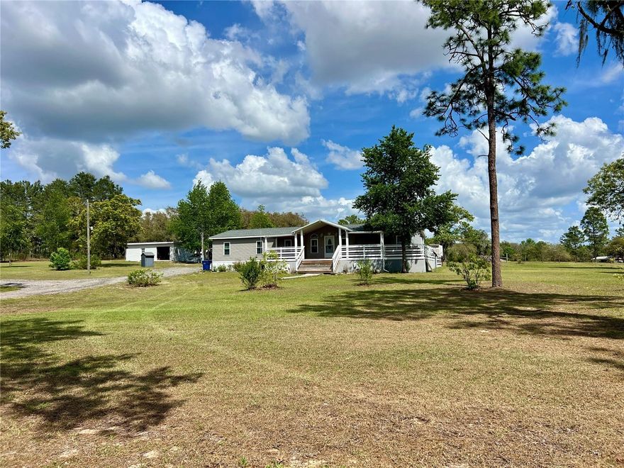 Ready to create the horse property you've been dreaming of? This beautiful 3+ acre property has been carefully cleared, with plenty of shade remaining for the horses, offering the perfect setting to shape the equestrian setup you've always envisioned.  With room for a barn, paddocks and a layout tailored to your needs, the possibilities are wide open.  A 60-foot round pen is already in place and could be reconfigured to temporary horse stalls while you bring your plans to life.  Located in a horse-friendly neighborhood with plenty of roads to ride your horses on. Set in a highly desirable location just one-third of a mile from blacktop, near Black Prong and the trails of Goethe State Forest, this property places you right in the heart of horse country.
The equestrian appeal is only the beginning- the home is equally impressive and perfectly suited for entertaining. A fabulous kitchen and an impressive wet bar create the ultimate gathering space, with features that include bar seating, a wine fridge, refrigerator, hot and cold water and large sink.  The pool table area create the ideal hangout space, while the screened porch, above-ground pool, outdoor shower, barbecue grill and fireplace make outdoor living just as inviting. Beyond its entertaining spaces, the home has been thoughtfully improved with an expansive front and side porch that offers gorgeous sunset views, along with fresh paint, new vanities, brand-new flooring, an a beautifully renovated primary bathroom.  The organized primary closet features convenient built-in shelving and an in-wall jewelry box, while one of the bedrooms is currently set up as an office, offering flexibiity for guests, hobbies, or working from home.  Conveniently situated between Williston and Bronson, this property puts you within easy reach of Black Prong, the World Equestrian Center, Cedar Key and the natural beauty of Florida's Gulf Coast.
