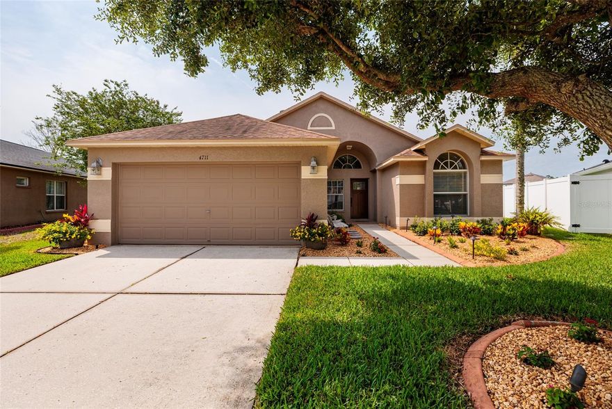WELCOME HOME to this beautifully maintained and UPDATED- 3 bedroom, 2 bath, 2 car garage home overlooking the lake located in the highly sought after community of Grand Oaks in Land O Lakes, Florida! This beautiful home sits on nearly 1/4 acre lot, fully fenced, with new sod and designer landscaping. The perfect backyard space for pets, entertaining and enjoying all the beauty of nature at this private oasis. Major upgrades to the home include: NEW roof, well maintained HVAC system, renovated bathrooms with granite and custom vanities, renovated kitchen with granite counter tops, upgraded tile flooring through entire home, updated light fixtures and new interior paint! This home has been meticulously maintained and is literally move in ready! The Grand Oaks community offers a low HOA with exceptional amenities including pool, hot tub, clubhouse, volleyball courts, playground, basketball court and fitness center! The community is highly walkable and bike friendly with sidewalks throughout leading to access to a unique wetland boardwalk trail for outdoor exploring! Ideally located in the heart of Wesley Chapel in Pasco County, this picture perfect home is just minutes from shopping, dining, schools, and medical facilities, with convenient access to I-75 and major roadways making commuting a quick breeze! You do not want to miss out on this worry free, move in ready home!