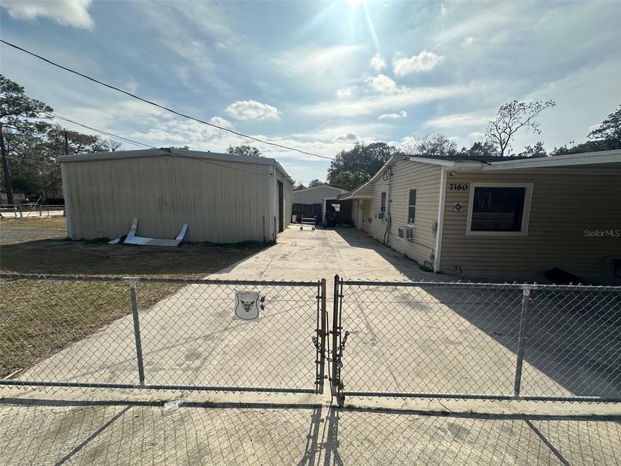 Versatile commercial property located on a fully fenced corner lot just off NE 7th Street in Ocala, across from Silver Springs State Park and near the Greenway and Baseline Rd. Previously used as a body shop, this B4 zoned property offers exceptional flexibility for a variety of commercial or industrial uses. This property features four total structures including two industrial buildings, an office and a manufactured home. The industrial buildings offer ample workspace with two bays approximately 30'x15' each with large 10' overhead door and two lifts well suited for automative, fabrication or service basted operations. An on- sire office provides dedicated administrative space, along with a restroom equipped with a shower, adding convenience for daily operations. The manufactured home, which carries a separate address of 674 NE 71st Terrace is included on the same folio number and offers additional flexibility- ideal for on site living, rental income or office use. The entire property is fully fenced, offering security, privacy and ease of operations. Its corner lot positioning provides excellent access and visibility while the proximity to Silver Springs State Park and surrounding traffic corridors enhances long term value and potential. This unique property presents a rare opportunity to acquire a muilti structure commercial site in a highly. desirable Ocala location with zoning that supports a wide range of uses.