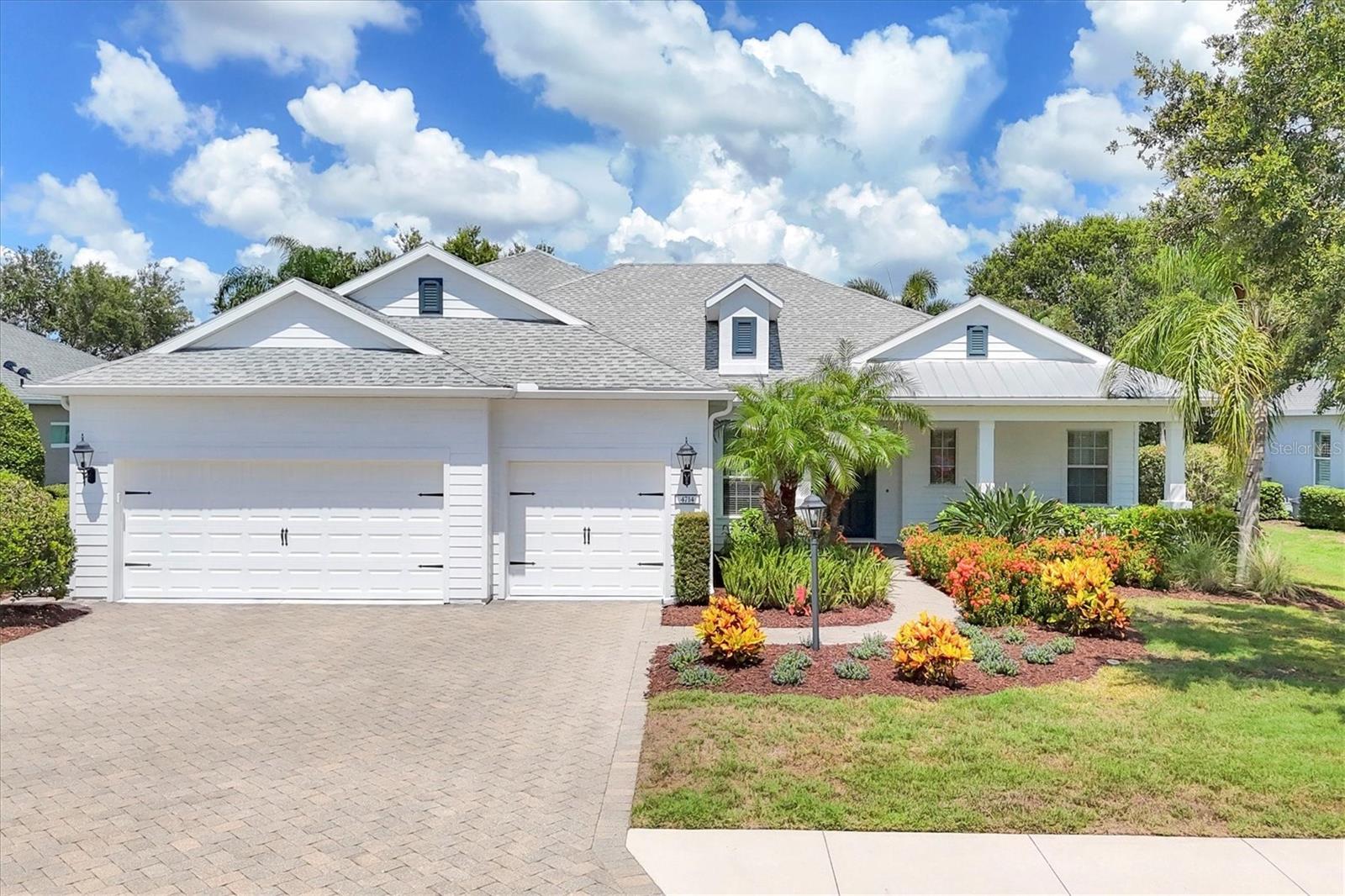 Situated on an oversized lot with panoramic lake views, this beautifully upgraded and meticulously maintained Neal-built Harmony II floor plan offers the perfect blend of luxury, functionality, and resort-style living. Located in the maintenance-free and privately gated section of Central Park in Lakewood Ranch. This 4-bedroom, 4-bath home features an upstairs bonus room with full bathroom, which can be used as a 4th bedroom or theater/game room, wired for a projector and surround sound.
A charming covered front porch welcomes you into the open-concept design. The spacious great room features tray ceilings, crown molding, recessed lighting, and triple pocket sliders that lead to your outdoor oasis with a heated saltwater pool, lush landscaping, covered dining and seating areas, and gas hookup for your future outdoor kitchen. The chef’s kitchen boasts GE Profile stainless appliances, updated granite countertops and tile backsplash, oversized island, corner pantry, solid wood cabinetry, and a sunlit breakfast nook for casual dining. Enjoy formal meals in the spacious dining room, accented by elegant crown molding and a beautiful chandelier. The spacious primary suite features private lanai access, two walk-in closets with built ins, and a spa inspired ensuite bath with soaking tub, dual vanities, and walk-in shower. Two additional bedrooms share a well-appointed full bath with custom bead board decor.
The dedicated office/den with solid French doors provide a flexible space for work or relaxation while enjoying the serene pool/lake view from the double glass sliders. Could also serve as a 5th bedroom if needed. A guest/pool bath is conveniently located adjacent for easy access.
The oversized 3-car garage includes epoxy flooring, built-in cabinetry for ample storage, tool rack, and is pre-wired for an EV charger. Additional features include a laundry room with sink and custom cabinetry, designer finishes throughout, and beautifully landscaped grounds with irrigation. Walking distance to Gullett Middle School and Mona Jain Elementary.
Central Park offers a resort-style lifestyle with amenities including a clubhouse, fitness center, community pool, tennis courts, splash pad, playgrounds, dog parks, sports fields, walking trails, and year-round social events. HOA includes common and private lawn care and maintenance, and a dedicated community manager. Lakewood Ranch is the #1 top selling master planned community in the country with vibrant lifestyle, countless community events, shopping, dining, polo, A+ rated schools, close to I75, SRQ Airport and award-winning Gulf Coast beaches.