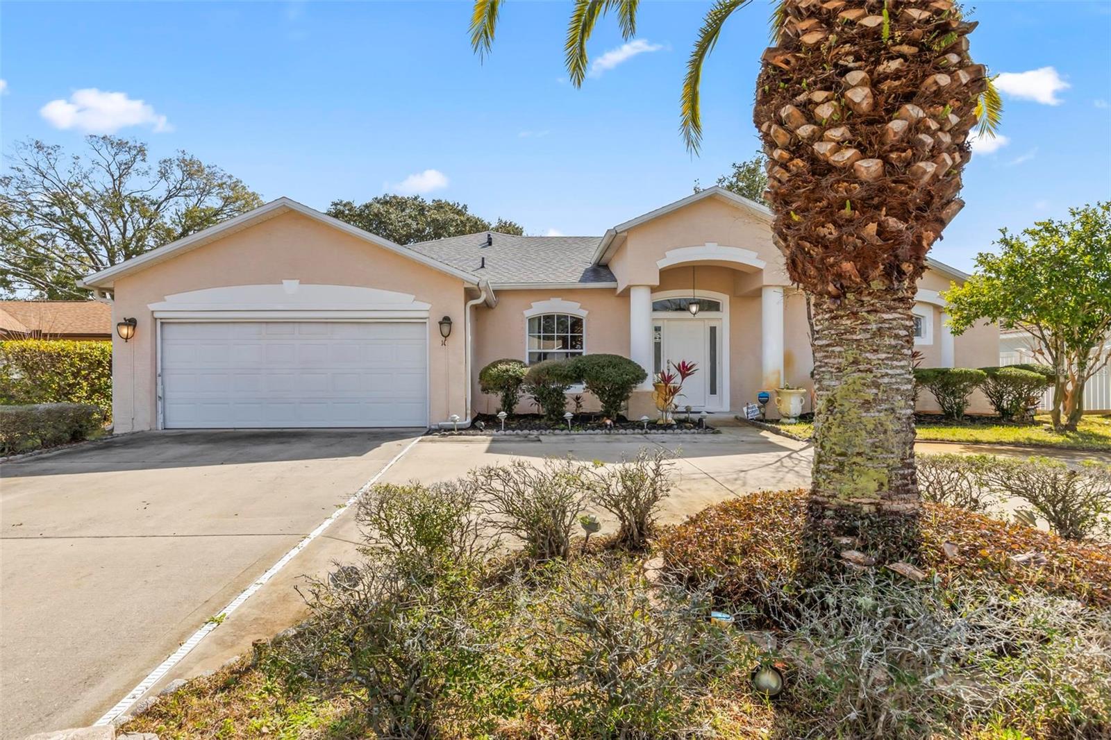 This is a spacious single-family home offering over 2,300 square feet of living space. Built in 2004, this residence features 3 bedrooms and 2 bathrooms. The interior boasts formal living and dining areas, a family room, and a covered patio. The spacious kitchen features center island, modern tile backsplash and large pantry. The flooring includes marble and tile throughout, with new LVP is the primary bedroom. The primary suite offers a roomy walk-in closet and a luxurious en-suite bathroom with dual sinks, a walk-in shower, and a separate tub. Additional features include a circular driveway, well-maintained landscaping with beautiful palm trees.
