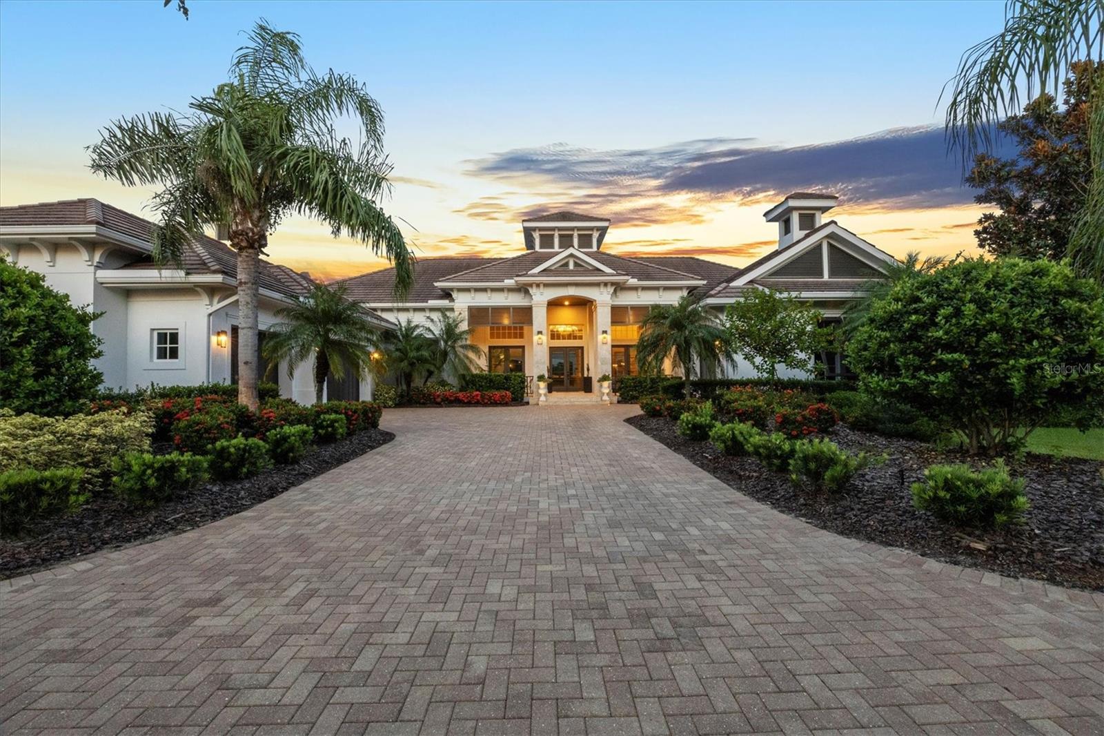 Welcome to 8009 Bounty Lane—A masterfully designed estate offering 4,484 square feet of refined living space, perfectly positioned within one of Bradenton’s most prestigious gated communities. This 3-bedroom, 3.5-bathroom residence embodies a seamless blend of elegance, comfort, and modern function, enhanced by a private pool, whole-house generator, and carefully selected upgrades throughout. From the moment you step through the grand entryway, soaring ceilings and expansive living areas set the tone for timeless sophistication. Architectural details and thoughtful finishes add warmth and character, while large windows bathe the home in natural light. The open floor plan encourages effortless flow, making it equally inviting for quiet relaxation or lively gatherings. At the heart of the home lies a chef’s kitchen designed to impress. Outfitted with premium appliances, custom cabinetry, a generous center island, and open sight-lines to the main living and dining spaces, this kitchen is ideal for both casual meals and upscale entertaining. The expansive primary suite serves as a true private retreat, complete with a sitting area, spa-inspired bathroom, oversized walk-in shower, soaking tub, dual vanities, and a custom-designed walk-in closet. Two additional guest suites—each with its own private bath—provide unmatched comfort and privacy for family and friends. Outdoor living is elevated to new heights with a spacious screened lanai, sparkling pool, and multiple lounging and dining areas. A fully fenced portion of the yard offers a secure haven for pets, while the whole-house generator ensures uninterrupted comfort year-round. Life at 8009 Bounty Lane extends well beyond the walls of the home. Residents of this sought-after community enjoy resort-style amenities including a beautifully appointed clubhouse, full fitness center, sauna, on-site restaurant, scenic parks, a basketball court, dog park, and a stunning resort-style pool—all within a secure, gated setting. Ideally located just minutes from Lakewood Ranch, world-class golf courses, fine dining, boutique shopping, and the sugar-sand beaches of Florida’s Gulf Coast, this residence combines luxury living with everyday convenience. 8009 Bounty Lane is more than a home—it’s a lifestyle. A rare opportunity to own a residence where elegance, privacy, and location converge in perfect harmony.