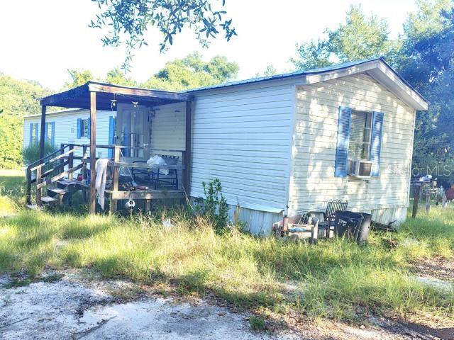 INVESTOR OPPORTUNITY - 2001 mobile home on 1.25 private acres in Greenwood, FL. 924 sq ft with open floor plan. COMPLETE REHAB NEEDED - property requires full renovation throughout including flooring, bathrooms, kitchen, and deep cleaning. Perfect for experienced investors and contractors seeking rental income or flip potential. Large lot offers excellent privacy. Property sold AS-IS.