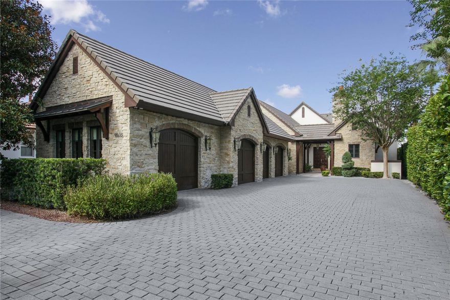 Located along Hole #4 of Lake Nona’s prestigious golf course, this contemporary English cottage includes four bedrooms, five full and one half bathrooms among its 5,646 square feet.
Authentic stonewalls and timeless wood detailing welcome you into the courtyard entrance of this single-story floor plan. The modern-day luxuries and high-end finishes of this home, combined with its traditional architectural details, create a stunning transitional style.
An open-concept great room, filled with natural light, features meticulous details, including marble floors, an exposed, wood-beamed ceiling, a built-in entertainment center and multiple sets of glass doors that lead to the outdoor living area.
The gourmet kitchen offers a large center island with beverage sink, a caterer’s kitchen, a hidden walk-in pantry, double ovens, and a six-burner gas cooktop and hood.
Located in its own private wing, the master suite comes fully equipped with a morning bar, dual wardrobes and vanities and overlooks breathtaking views of the golf course.
Outdoor entertaining comes easy with the home’s covered lanai, summer kitchen and marble pool deck. The unique courtyard pool and spa is enclosed with a glass railing.
The highlight of this residence is a second-level covered lanai with retractable screens and invites the opportunity to fully enjoy Florida’s temperate climate.
Additional features include: Family room with wet bar & wine refrigerator; Home office; Fitness room; Three-car garage with attached air-conditioned golf room; Air-conditioned fully finished attic.