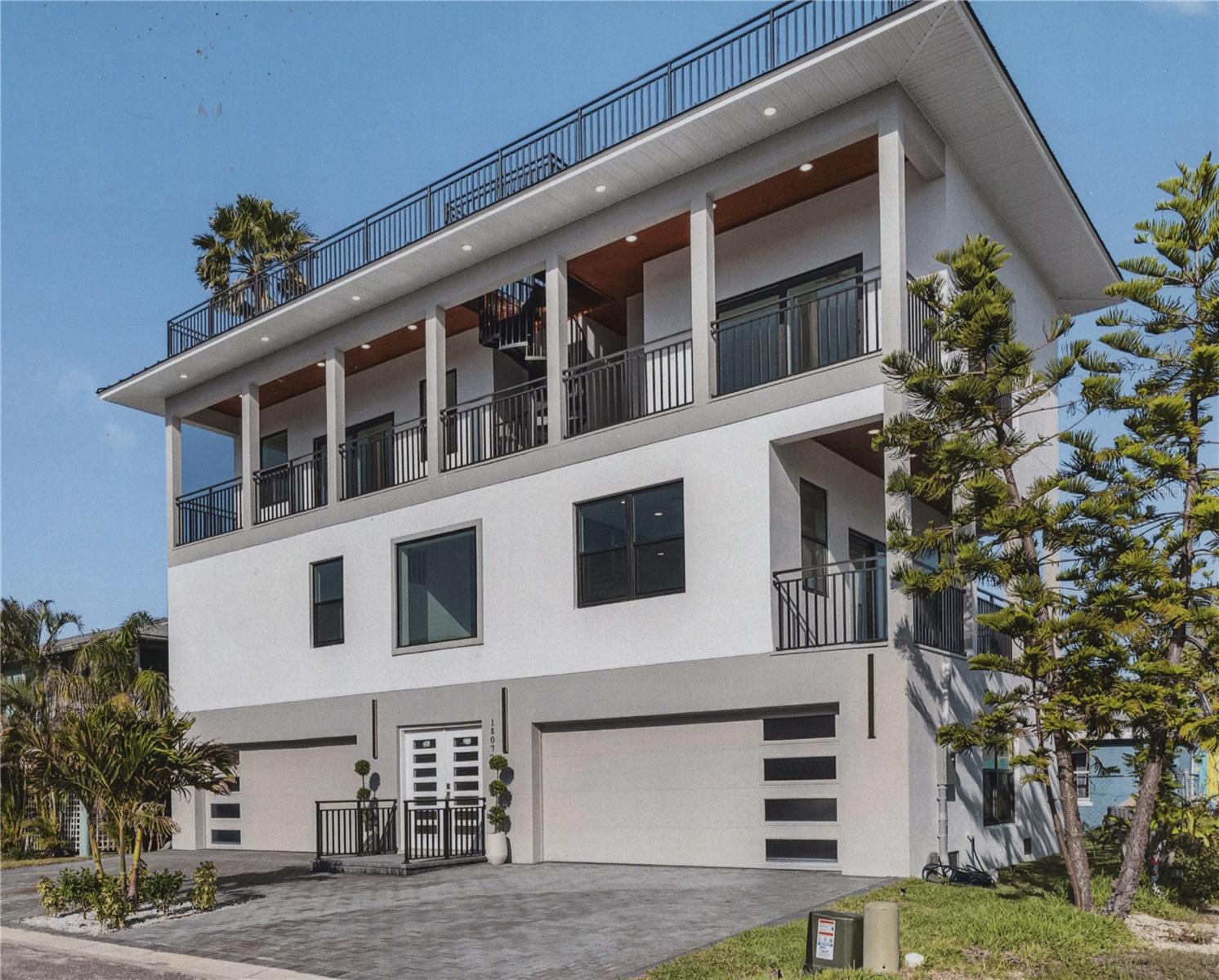 Brand new fully conforming hurricane resistant property. Completed just prior to Helene and Milton and while substantial damage was sustained in the neighborhood there was none here. This demonstrates that if you build to meet or exceed the current codes you can evacuate the area for the duration of the storm and return to a undamaged home located on the islands with its own private beach club, amenities to spare. 4 car garage 3 BR/3.5Ba/2,500sf home with 5,000sf of real living space including a 1,000sf rooftop deck, multiple balconies. Picture watching sunrises, sunsets, firework, lighted boat parades and more from your huge 3rd floor party deck. Then go to your own private beach club with showers, picnic tables, tiki huts and enjoy the quiet warm surf of the Gulf of Mexico. For a break take a book and go out to one of the 5 Intracoastal seawall benches to read or just ruminate. Walk out to the Friendly Tavern for a drink and some beach bites, enjoy Ice Cream from the Candy Kitchen the opportunities are endless.