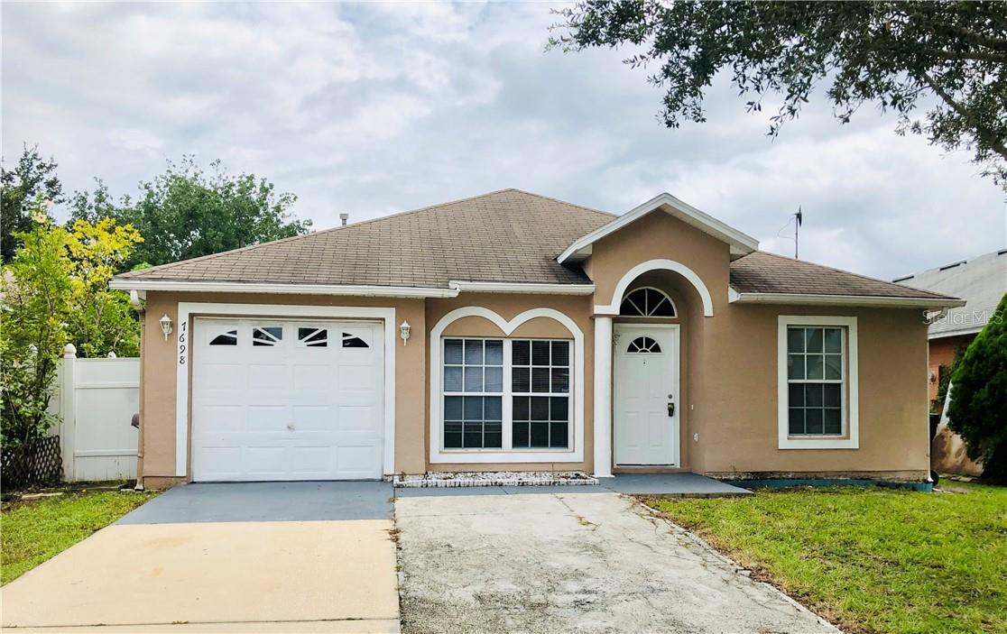 4-bedroom, 2-bathroom home with a fenced backyard. The kitchen features a breakfast bar that opens to the living room/dining room combo. The master bedroom offers dual closets and access to the master bathroom with a shower/tub combo. The property also includes an inside utility area, washer/dryer hookup, and an attached one-car garage.