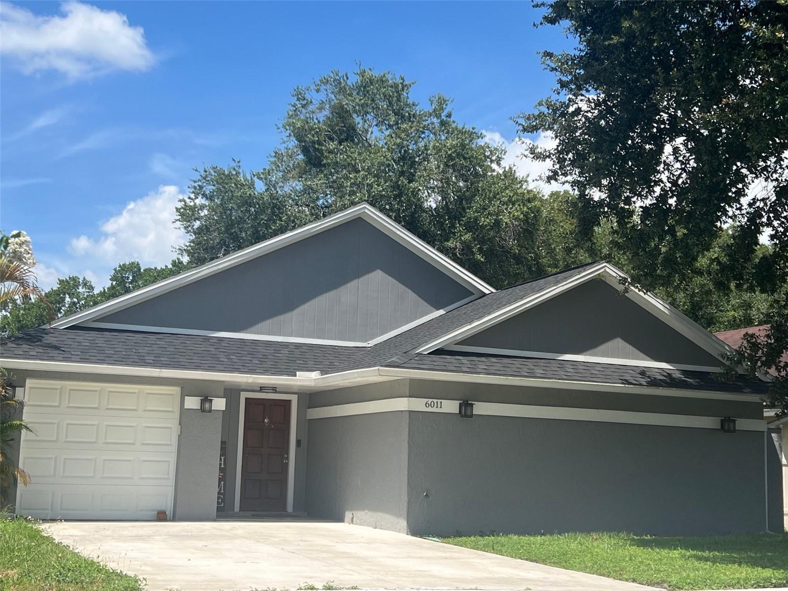 This spacious 3-bedroom, 2-bath home at 6011 Lemon Tree Ct in Tampa is move-in ready and offers over 1,800 sq ft of living space. The open split floor plan includes a versatile bonus room that works perfectly as a home office or extra storage. You’ll love the updated kitchen with plenty of cabinet space, a large breakfast bar, and an easy flow into the living and dining areas. The primary suite features a private bath with modern finishes, while tile and hardwood floors throughout make cleaning simple. Step outside to the patio and fenced backyard, ideal for relaxing or entertaining. With an efficient HVAC system, hurricane-rated sliding doors, and energy-saving features, this home is designed for everyday comfort. Conveniently located near schools, shopping, dining, and major highways, this property offers the perfect balance of space, convenience, and lifestyle.