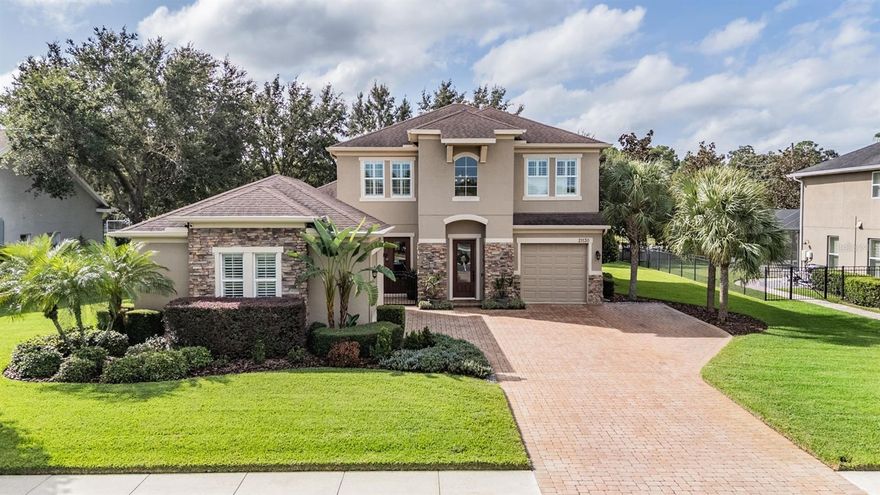 LOCATION! LOCATION! LOCATION!  Luxurious LAND O' LAKES Upscale home for sale in A Rated School district only 1 block away form Sanders Elementary and Angeline Bus stop!  Welcome to an Exceptional, Move-in READY Taylor Morrison built home located in the EXCLUSIVE, LAKEFRONT, GATED community of Lake Thomas Pointe.  This customized Dalton II floor plan offers over $100,000 in recent high-end upgrades and nearly 3,200 square feet of beautifully designed living space. Nestled on a spacious lot with mature landscaping, this property boasts a rare combination of casual elegance from the Gorgeous stacked stone elevation, extended brick paver driveway, and gated courtyard entrance that creates an IMPRESSIVE first impression! Once inside, enjoy soaring volume ceilings, abundant natural light and an open-concept layout that connects the gourmet kitchen, living, and formal dining spaces. The kitchen features upgraded maple cabinetry with crown molding, granite countertops, stainless steel appliances and a large island with breakfast bar... all ideal for entertaining. The first-floor owners retreat is thoughtfully designed with tray ceilings, wood floors, plantation shutters and a luxurious en-suite bath including a walk-in shower, garden tub and double granite vanities. A home office/den with hardwood floors at the rear of the home provides a quiet workspace or potential fifth bedroom. Upstairs, the expanded loft adds nearly 300 additional square feet, offering an ideal bonus/media space, surrounded by three large guest bedrooms—including one with a private ensuite bath. Throughout the home, you'll find designer touches like 5-inch baseboards, diagonally laid tile, crown molding, recessed LED lighting, custom blinds, and upgraded light fixtures and ceiling fans. Pocket sliders OPEN to a covered and screened lanai overlooking the large backyard... complete with a CUSTOM inground, heated pool, solar panels, paver firepit area, string lights and new sodded yard. This home is also equipped with a 2021 AC unit, new water heater, water softener, whole-house generator hookup, new gutters, minisplit AC and plantation shutters in the upstairs rooms. The spacious side-entry two-car garage plus a separate front-entry single-car garage adds flexibility and convenience. Interior laundry room with storage cabinets above includes washer and dryer. Located within one block of Sanders Elementary (STEAM magnet school with enrollment preference) and Land O’ Lakes Christian School, this 180-acre lakefront community offers peaceful living with access to scenic community dock on Lake Thomas, low-traffic streets, wide sidewalks perfect for biking or evening strolls. Close to shopping, restaurants, medical facilities and major highways for easy access to Airports and the Beaches! Don't miss this rare opportunity to own a truly upgraded, meticulously maintained home in one of Land O’ Lakes most desirable gated communities—CALL TODAY!