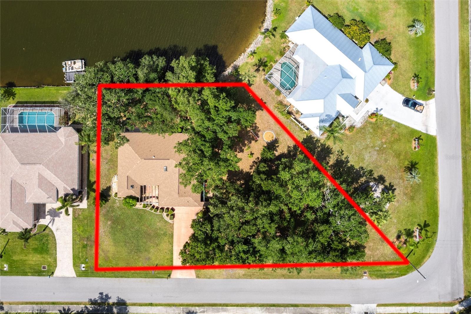 Lakefront Living at Its Finest – Updated Dual Master Suite Home on Nearly Half an Acre! BONUS: NOT IN A FLOOD ZONE
Every day feels like a vacation in this beautifully updated, Mediterranean-style home nestled under majestic oaks with 91 feet of serene lakefront on Lake Suzy. Enjoy breathtaking sunset views from your expansive screened lanai—pure peace and privacy with no rear neighbors.
Step inside to discover a spacious and inviting layout with two master suites—perfect for hosting guests or multigenerational living. This home has been thoughtfully updated with major improvements including a NEW ROOF (2022), NEW A/C (2018), NEW WATER HEATER, and NEW SEPTIC SYSTEM for peace of mind.
• The interior blends warm, sun-drenched charm with modern comforts:
• Soaring ceilings & skylights fill the space with natural light
• Luxury vinyl plank flooring throughout the main living areas
• A stunning galley-style kitchen with granite counters & backsplash, timeless shaker cabinetry, and abundant storage
• Cozy family room & bonus dining nook for everyday living and entertaining.
Both bedrooms are generously sized, with the primary suite featuring a spa-like bath, soaking tub, walk-in shower, and dual vanities. The second suite offers its own lanai access, full bath, and walk-in closet—ideal for long-term guests or additional family.
Outdoors, unwind on the private front patio with open-beamed ceiling or take in the tranquil lake views from the back. The oversized lot offers endless potential—room to garden, relax, or even add a pool.
Located just minutes from I-75, shopping, dining, and beaches—this is the rare blend of privacy, beauty, and convenience.
Homes like this don’t come around often—schedule your showing today and experience Lake Suzy living for yourself! **PLEASE ENJOY THE 3D INTERACTIVE VIRTUAL TOUR ASSOCIATED WITH THIS LISTING**