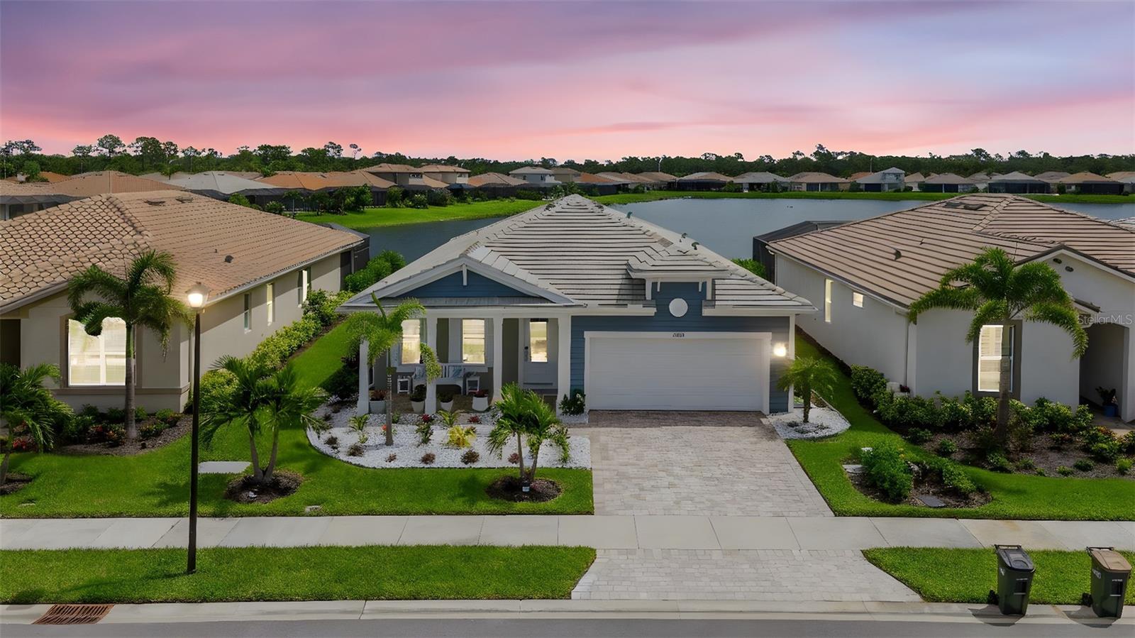 If you enjoy a pristine lakefront view, while sitting beside your fireplace featured wall on your lanai, overlooking your heated pool with the added luxury of being able to lower hurricane screening for air conditioned comfort, you’ve found your dream home here!
If you enjoy elegance, upgrades, and fine taste in decor and finishes, this property needs to go to the very top of your “Must See” list. Here are a few of the most elaborate upgrades:
Waterfront lot on the largest lake in Renaissance subdivision in Wellen Park, large heated pool, lanai with hurricane screening, large, walk-in closet space with customized shelving, uniform porcelain flooring with professionally applied sealant for grout protection. Customized wine and coffee bar with see-through doors and glass shelves. Stainless steel appliances with top load microwave and a lighted hood vent over the glass cooktop stove. Oversized garage has been customized with storage shelves and sliding doors to maximize the curb appeal of the rubberized custom floor finish.
Rest assured your water treatment system by Culligan will protect your health and your plumbing.
This 3 bedroom, 2 bath, and office, home is finished off like no other! Whether you choose to start or end your day on the front porch or at poolside, you will feel like you’ve just checked in at a resort!
You will be absolutely overwhelmed by the elegance infused throughout this home by the $213,300 of add-on features. You cannot build a home of this size and quality finish today for the asking price of this home as it sits on this lot! Come and see for yourself! Furnishings are negotiable, but are not included in list price. Room measurements are estimates and must be verified by Buyer(s).