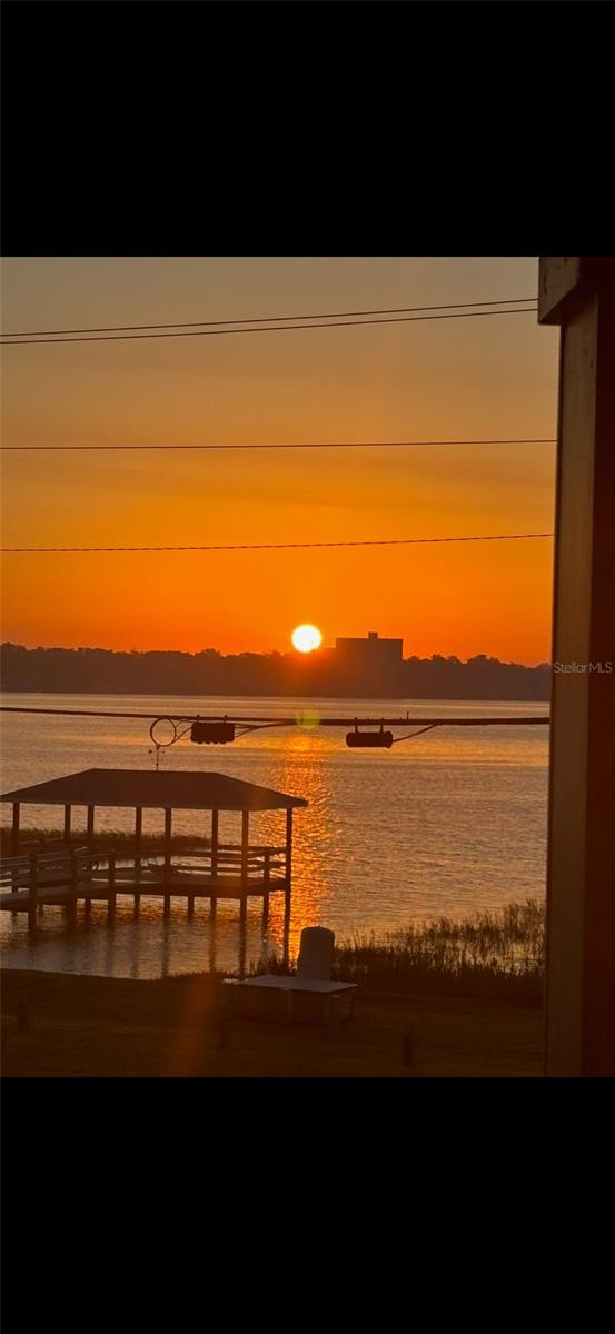 Discover the idyllic lake life of this charming and peaceful condo in the desirable 55+ community of Winter Haven, Florida. This unit offers a beautiful quaint view of Lake Howard and the private covered dock, giving you a serene Lakeside experience. Featuring two bedrooms and two bath FULLY FURNISHED for an effortless move-in. The living room includes a comfortable couch, two recliners and a TV, while each of the two bedrooms has a queen size bed and dresser. The galley kitchen is ready for your first meal, equipped with pots pans and dish ware. Major updates include a new HVAC in 2021 and all new windows and hurricane two rated patio doors. The spacious living in dining room combo area is brightened by new sliding glass doors which are mirrored in the master bedroom, the community provides an array of amenities, including two pools and walking trails.