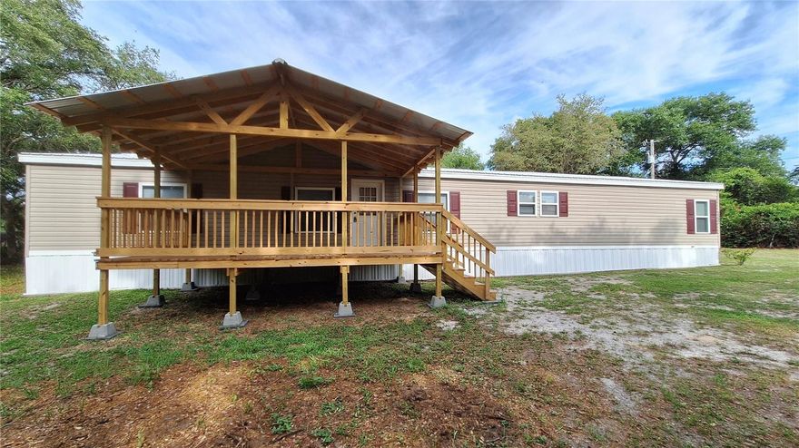 4 bedroom, 3 full baths & 1 half bath. 1.31 acre semi secluded flag lot. Owner will financed with $50k down. Located in Eagles Landing. Updated with metal roofing. Built in 2000 completely renovated in within the past 5 years. 27'x76' manufactured home with detached 2 car carport, 10'x20 lawn equipment shed with double drive through doors. 20'x12' front lanai, 12'x16' lanai over looking the back yard. All new carpet and LVP throughout. Kitchen offers all appliances, side by side refrigerator, microwave, dishwasher, range, multiple cabinets, granite counter tops. Butcher block island with electric and additional storage. 2 master bed & baths. The primary master bedroom and bath includes walk in closet, ceiling fan, his & her granite counter top vanity. Oversized tub, custom ceramic tile walk in shower with his/her shower heads and glass enclosure. Main living room has electric fireplace and multiple windows giving views of the back yard. Partitioned dining area with convenient access to the kitchen and den with wood burning fireplace, coat closet. Beds 3 & 4 also have walk in closets. The secondary master also gives you private access to your ceramic tile walk in shower, granite countertop vanity. Laundry room/mud room includes half bath, built in storage for linens and additional space for setting up a folding table. Smoke detectors, updated 50 gal water heater. Updated metal roof with additional insulation when installed. Double pane insulated windows. Marion County Utilities is the water system with a $12.50 base fee per month. Septic is located in the back yard. Additional insulation was added behind the vinyl siding. No HOA to deal with on this one. Come and live in free Florida. Spectrum is the internet provider for this area. Owner will finance with $50k down terms negotiable. A portion of the SE corner of the property is in AE flood zone. If owner financed the owner will not require flood insurance. No structures are in the flood zone.
