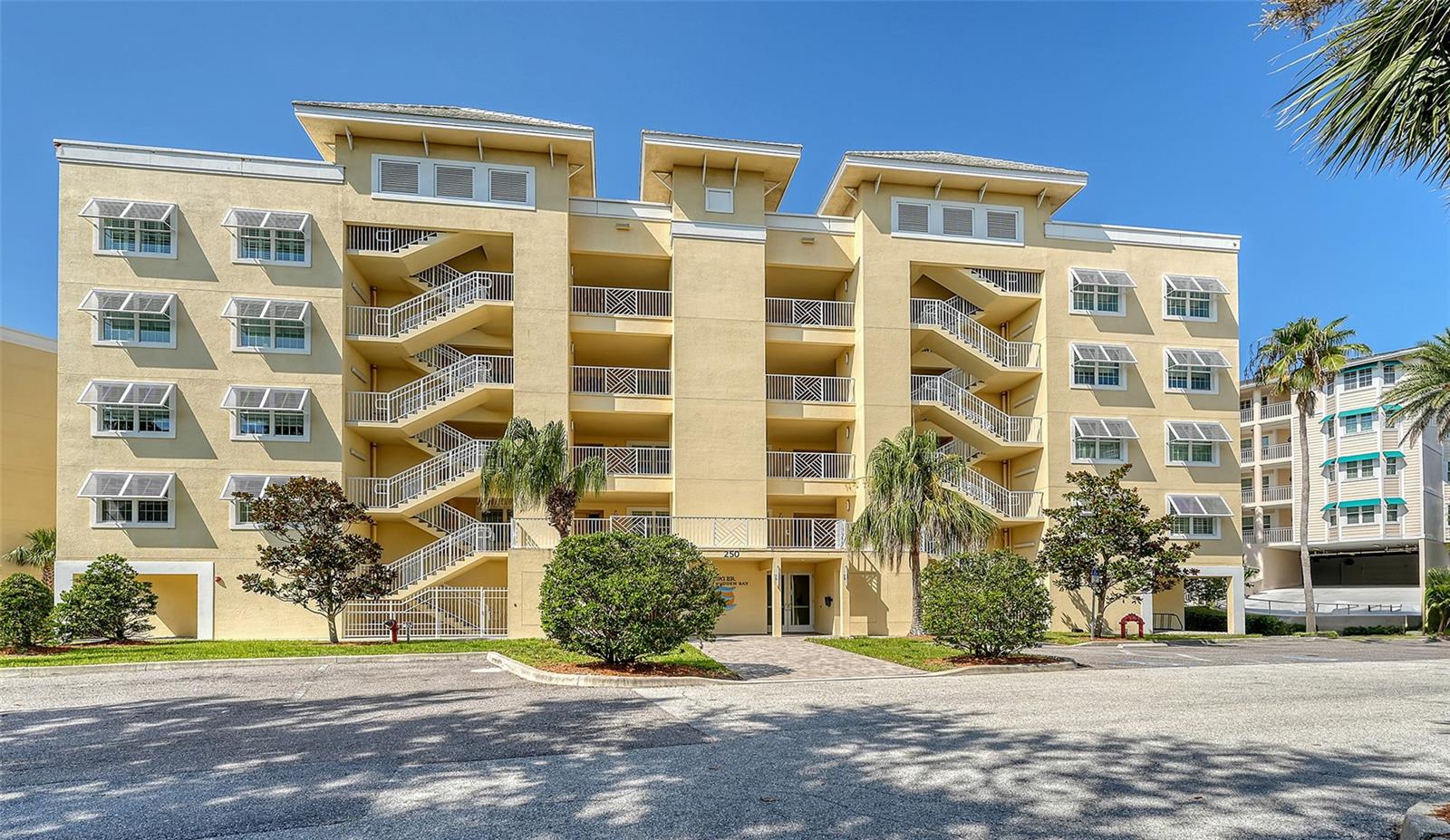 WHAT A VIEW! Prepare to be captivated by jaw-dropping sunsets from your oversized, private, screened-in balcony, offering unobstructed vistas across Little Sarasota Bay to the peaceful barrier island of Casey Key. Welcome to Edgewater at Hidden Bay — a gated, 12-acre resort-style community perfectly positioned between the charm of historic Venice and the cultural vibrancy of downtown Sarasota. This impeccably maintained three-bedroom, two-bathroom plus den residence offers panoramic water views and an easy, elegant coastal lifestyle. Step inside to a bright, open-concept layout with a spacious living and dining area — perfect for entertaining or relaxing while soaking in the scenery. The gourmet kitchen is a chef’s dream, featuring stainless steel KitchenAid appliances, granite countertops, 42” real wood cabinetry, counter-height seating, and abundant storage. Coffered ceilings and 5-inch baseboards add refined architectural detail throughout. The expansive primary suite is a tranquil retreat with direct access to the balcony, dual walk-in closets, and a spa-inspired bathroom boasting dual vanities and a glass-enclosed shower. A split bedroom layout offers optimal privacy, while the full-size laundry room includes built-in cabinets and a sink for added convenience. Additional highlights include Kohler plumbing fixtures, hurricane-impact windows and doors, and an abundance of natural light throughout. Offered furnished, this home is move-in ready. Edgewater at Hidden Bay delivers exceptional amenities: a heated resort-style pool and spa, clubhouse with catering kitchen and library, fitness center, tennis and pickleball courts, kayak launch and storage, scenic boardwalk through lush mangroves, and a private fishing pier (currently being rebuilt). Enjoy unmatched access to award-winning beaches (just 6.5 miles to both Siesta Key and Nokomis Beach), Bay Street Park, Legacy Trail, Oscar Scherer State Park, shopping, dining, marinas, golf, and premier medical facilities. This is more than a home — it’s a lifestyle. Schedule your private showing today and discover the very best in waterfront living.