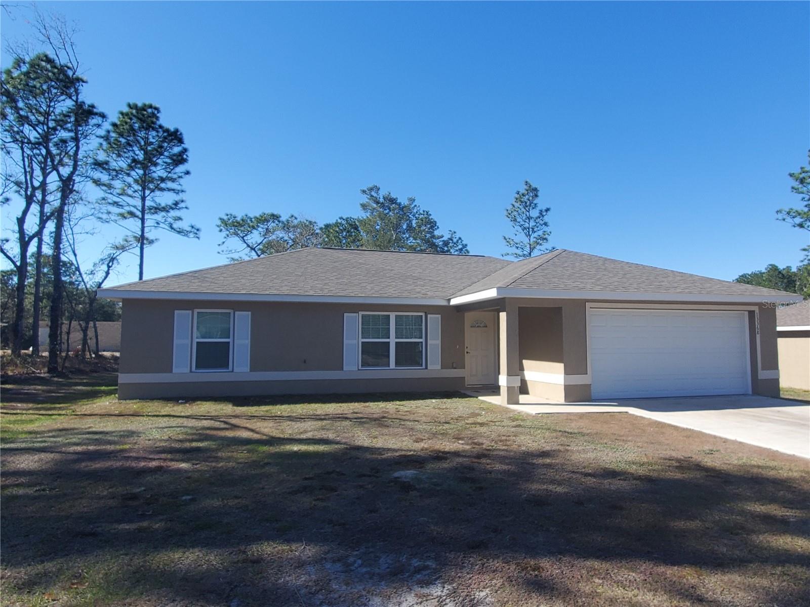 Well-maintained newer home situated on a spacious 0.3-acre lot. This 3-bedroom, 2-bath residence features a block and stucco exterior, an attached 2-car garage, and a functional open floor plan. The kitchen includes beautiful cabinetry, a refrigerator, range with hood, and dishwasher. The primary suite offers a walk-in closet and en-suite bath. Tile and carpet flooring throughout. High-efficiency windows help reduce utility costs. Washer and dryer included. Plenty of yard space for outdoor enjoyment. Move-in ready and available for lease.