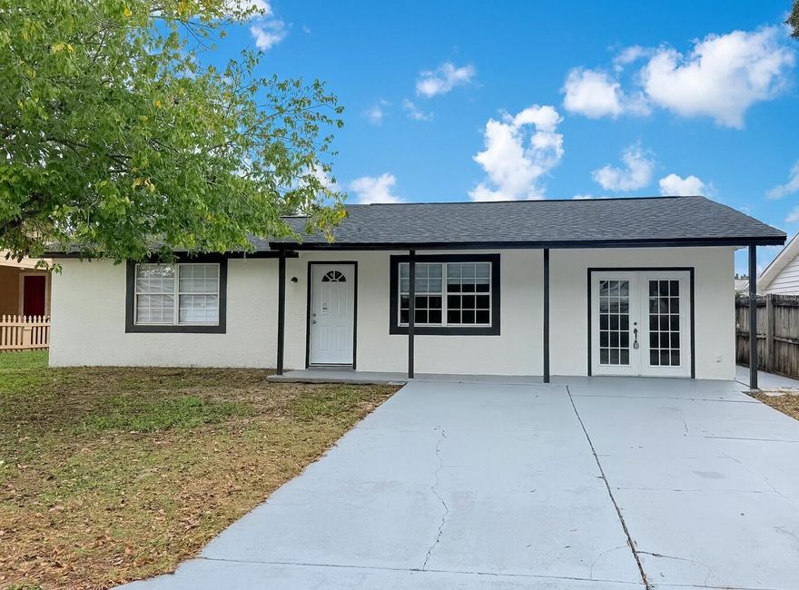 Beautifully fully renovated home located in a NO FLOOD ZONE with NO HOA packed with upgrades and ready for new owners. It boasts a new roof (2025), new AC (2025), and luxurious wood laminate flooring throughout. The interior and exterior have been freshly painted, creating a modern, fresh look. The heart of the home is the new kitchen, featuring quartz countertops, updated stainless steel appliances, and sleek cabinetry. Both bathrooms have been updated with a modern style, and the home includes a large ADDITIONAL ROOM, which can easily be converted into a 3rd bedroom. Located close to shopping, grocery stores, beaches, and all the essentials, this home combines convenience and style. With No CDD, No HOA, and No flood insurance required.  An exceptional opportunity awaits you. Don't miss out!