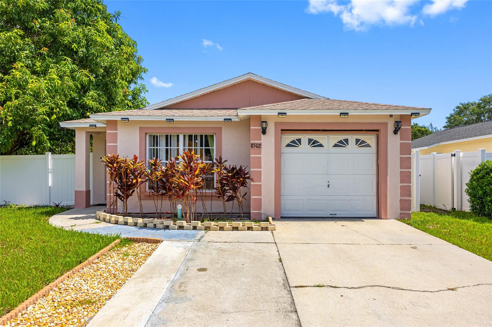 BEAUTIFUL 3 BEDROOMS, 2 BATHROOMS AND A 1 CAR GARAGE HOME LOCATED IN THE CITY OF TAMPA! THIS HOME WAS FRESHLY PAINTED ABOUT THREE MONTHS AGO AND HAS A FENCED CORNER LOT FOR PRIVACY WITH FRUIT TREES IN THE BACKYARD. THE ROOF WAS INSTALLED IN 2021. AS YOU ENTERED THE DRIVEWAY, YOU'LL NOTICE THAT THE DRIVEWAY WAS EXTENDED TO PARK TWO VEHICLES. THERE IS A SECURITY SYSTEM OWNED BY THE SELLERS AND MONITORED BY ADT AND CITY OF TAMPA POLICE. ALSO, THERE ARE FOUR SECURITY SENSORS ON ALL FOUR CORNERS OF THE HOUSE ATTACHED TO AN INTERIOR MONITOR TO VIEW THE EXTERIOR AREAS OF THE PROPERTY. THE SCREEN DOOR AND ENTRANCE DOOR WERE REPLACED WITH DESIGNERS GLASS DOORS. THE ENTIRE HOUSE HAS CERAMIC TILES, CROWN MOLDING IN THE LIVING AND DINING ROOM, NEW CHANDELIER IN THE DINING ROOM, PRIMARY BATHROOM WAS RENOVATED WITH A WALK-IN SHOWER FOR HANDICAP ACCESS, SECONDARY BATHROOM HAS A BATHTUB, GARAGE HAS TWO CEILING FANS AND THE BACKYARD HAS A 9X11 CONCRETE BLOCK STORAGE SHED FOR ADDITIONAL STORAGE. THIS HOME IS LOCATED NEAR BUSCH GARDENS, SHOPPING, DINING, ENTERTAINMENT, UNIVERSITY OF SOUTH FLORIDA, HOSPITALS AND MAYOR HIGHWAYS.