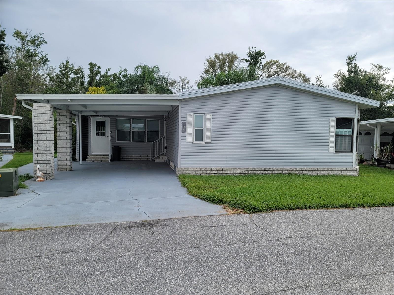 2 Bedroom, 2 Full Bath mobile home in a 55 plus, Sweetwater Community. Shed with Window unit located in rear of home. New Siding, Completely re-plumbed in 2025. New Metal Roof and AC replaced in 2024. Includes Golf Cart, Stove, Refrigerator, Microwave, Washer/Dryer, Livingroom Furniture (excluding TV and 1 recliner), Kitchen Furniture, Florida Room attached to mobile with AC and furniture included. Bedroom furniture includes beds, chest of drawers and desk. Laundry room is inside kitchen. Community offers Clubhouse, 18 hole Golf Course, Pool and Hot Tub, Tennis and Pickle Ball Courts, Shuffleboard ,Fitness Room, Boat Ramp access to Lake Henry, boat slips available. All room sizes are approximate.