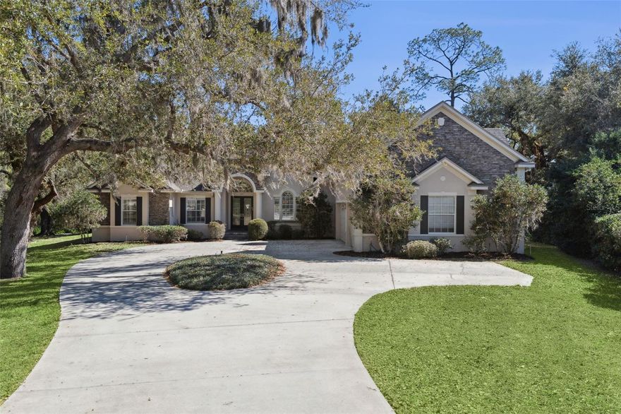 Under contract-accepting backup offers. Nestled at the end of a quiet cul-de-sac in Mill Stream Estates, this beautifully maintained estate property offers a rare combination of privacy, space, and everyday convenience just minutes from Lake Nona, Medical City, the airport, and major roadways.Set on 5.6 wooded acres, the property lives like a private retreat. A circular drive and mature oaks create a welcoming sense of arrival, while the home’s elevated presence and 3-car garage add both function and curb appeal. Inside, high ceilings, fresh interior paint, and newly installed downstairs wood flooring (2026) create a warm, comfortable atmosphere. The thoughtful layout provides multiple gathering areas as well as quiet spaces, including a dedicated office with closet that offers flexibility for remote work, hobbies, or additional sleeping space.The heart of the home flows naturally toward the outdoor living area. The family room opens to a spacious screened lanai and heated saltwater pool, and the primary suite offers direct access to the pool deck for easy indoor-outdoor living. Whether hosting holidays, casual get-togethers, or relaxed evenings overlooking the trees, the setting lends itself to becoming a place people naturally return to year after year.Practical features support everyday living, including an oversized laundry room with utility sink, well and septic service, and a circular driveway with ample parking. Major system updates provide confidence and peace of mind: roof (2022), HVAC systems (2020 and 2026), water heaters within the last two years, new pool pump (2026), and new well pump (2026).Offering a balance of seclusion and accessibility, this property delivers the space of an estate setting while remaining close to Lake Nona amenities, shopping, dining, and commuter routes. A unique opportunity to enjoy privacy without sacrificing convenience.