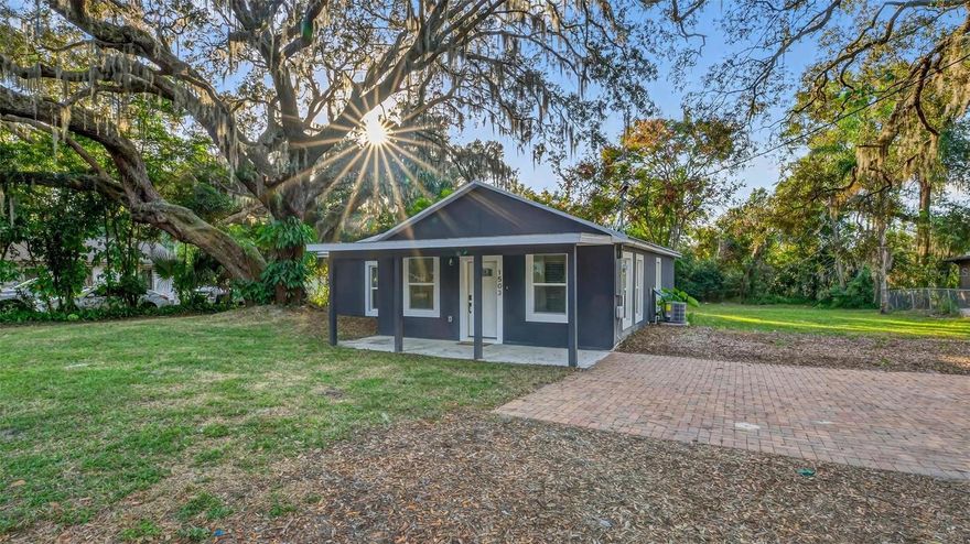 Set on a one-third acre lot just one block from N. Donnelly Street, this thoughtfully updated single-story home places you minutes from downtown Mount Dora’s shops, lakeside dining, art festivals, and antique markets while offering space, privacy, and modern comfort, permitted and fully renovated in 2024 with a metal roof, updated plumbing and electrical, new A/C, new windows, and an added bathroom, featuring light brown luxury vinyl plank flooring throughout, an open-concept living and dining area with a cathedral ceiling and recessed LED lighting that creates an airy, light-filled atmosphere, a refreshed kitchen with shaker cabinetry, stylish gold hardware, quartz-style countertops, and stainless steel appliances, two primary bedroom suites providing flexible living arrangements, an interior laundry and oversized utility room with washer and dryer hookups, tankless water heater, and additional storage or mudroom potential, completely remodeled bathrooms including a walk-in shower and a bath and shower combination, a covered front porch, a newly installed red brick driveway, and an expansive yard with ample space for boat parking and Class A RV parking, with furnishings negotiable, all located in one of Central Florida’s most charming historic communities approximately 40 minutes from Orlando.