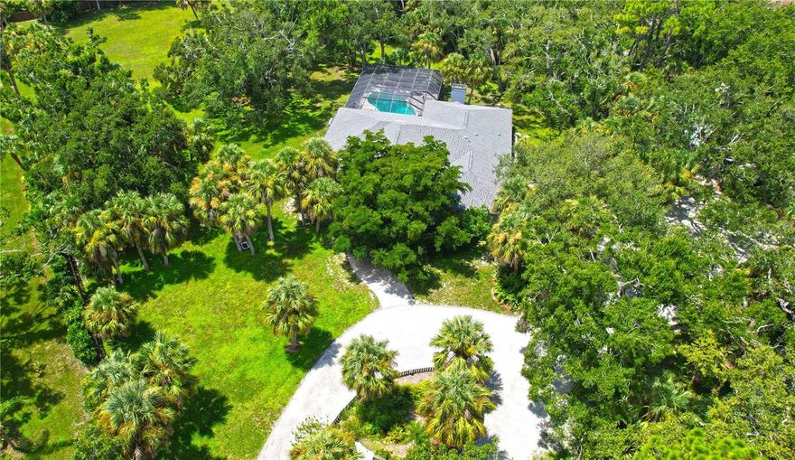 Discover a truly unique opportunity with this private 1.9-acre property offering freedom with no deed restrictions, Horses allowed, no HOA, and no flood insurance required. Just minutes from the new Sarasota Memorial Hospital in Nokomis, Nokomis Beach, and historic downtown Venice, this home combines privacy with convenience. The residence features three bedrooms and three full bathrooms, including a potential mother-in-law suite with its own entrance including an office or possible fourth bedroom, family room, bathroom, and an oversized storage room with custom floor-to-ceiling cabinetry. Recent updates include a new roof and gutters in 2024, a three-zone A/C system under warranty, and fresh exterior paint in 2021. Inside, bamboo floors enhance the living and dining areas, while outside, the grounds are fully fenced with a privacy gate. Enjoy a 36x16 pool that is nine feet deep with paver decking, under a 54x36 screen enclosure, plus a detached two-car garage and a 20x20 outbuilding for additional storage. Surrounded by serene views in every direction, this irreplaceable property offers the perfect blend of peace, space, and proximity to shopping, dining, medical facilities, and pristine Gulf beaches.