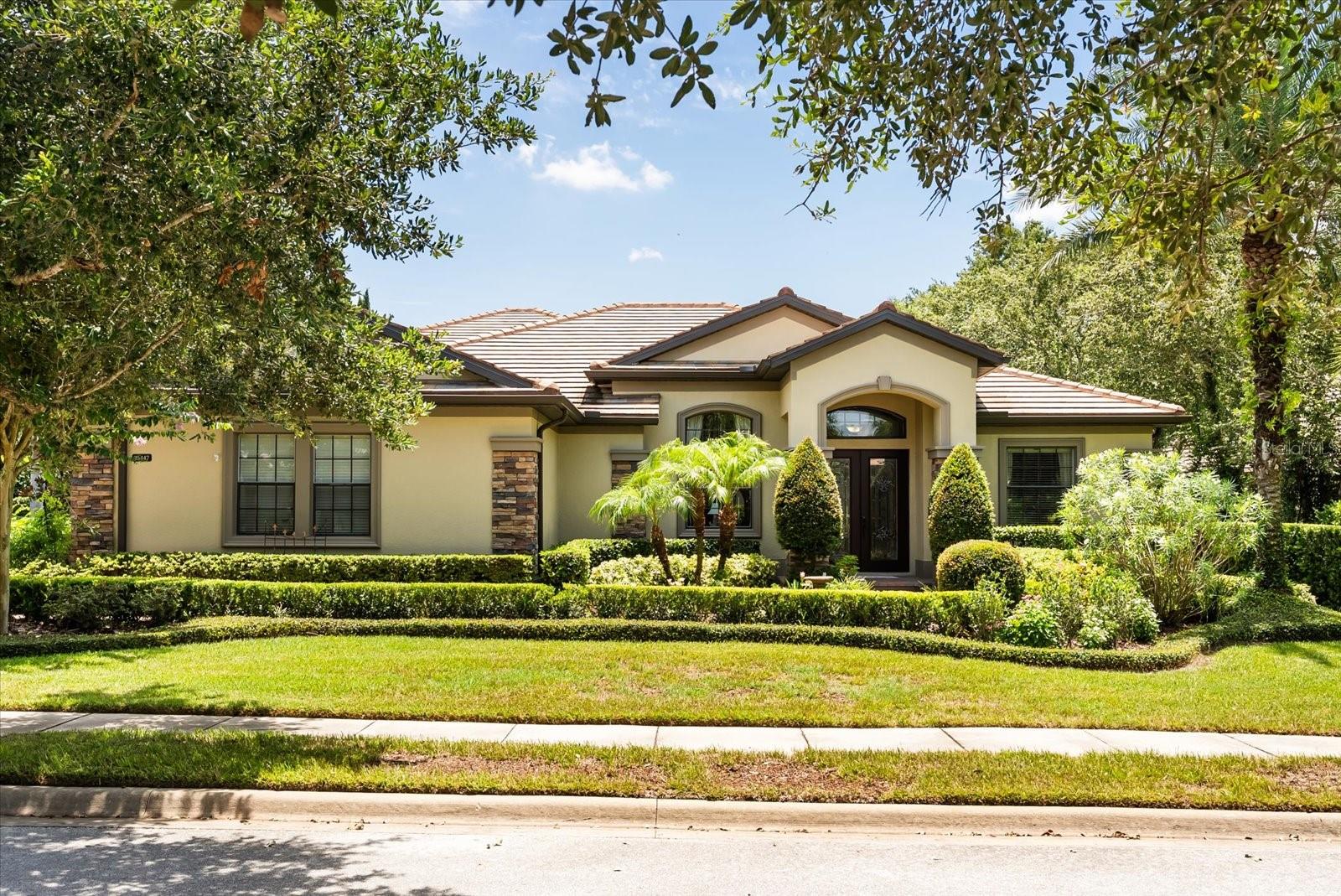 This beautiful home is located in the prestigious Red Tail Community with resort-style, golf course living! Discover true luxury in this elite gated community in Sorrento, where serenity, craftsmanship, and golf course living converge. This stunning two-story estate offers nearly 3,500 square feet of impeccably maintained space, featuring 4 bedrooms, 4 bathrooms, a dedicated office, and a generous upstairs bonus room —all set on a beautifully manicured homesite with golf course views. From the moment you arrive via the long paved driveway, you're greeted by a striking stone-accented exterior, three-car side-entry garage, and grand double-glass door entry. Inside, the ambiance is immediately upscale—featuring dark hardwood flooring, formal living and dining rooms with crown molding, and designer lighting. The chef-ready kitchen is as functional as it is stylish, boasting dark granite countertops, with breakfast bar, built-in stainless-steel oven and microwave, gas cooktop with vent hood, and abundant custom cabinetry. Adjacent is a light-filled breakfast nook, and a spacious family room with views of the outdoor oasis—perfect for both entertaining and daily relaxation - all overlooking the screened pool and spa, complete with lounge shelf and covered seating—the perfect setting for outdoor entertaining or serene relaxation with golf course views. The primary suite is regal in proportion, with tray ceilings, walk-in closet, additional closet and a luxurious bathroom showcasing dual granite vanities, a glass-enclosed shower, separate soaking tub, and a secluded water closet. A home office with dual-access from the foyer and primary bath delivers seamless convenience and privacy. The other three bedrooms on the main level feature plush carpeting and ceiling fans, offering flexible comfort for family or guests. Upstairs, a spacious bonus room with its own full bath serves as an ideal entertainment hub, guest suite, or multi-purpose retreat. Living in Heathrow Country Estates means embracing a lifestyle built around peace and leisure—golf cart friendly, with vehicle restrictions ensuring tranquility and safety. Lush common areas, gently winding walking trails, and scenic landscaping create a serene backdrop for daily life. With nearby golf access, upscale neighbors, and close proximity to Sorrento’s Lake County lifestyle, you'll enjoy both privacy and convenience. Book your exclusive showing today!