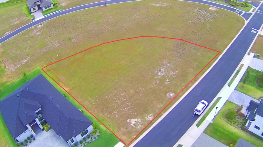 Paradise awaits...discover Florida living at its finest in the exclusive gated community of Water Ridge.   This spacious .39 acre lot provides an excellent opportunity to build a custom dream home in a serene community. Water Ridge is an exquisite  community overlooking 3 lakes and featuring abundant amenities including a fitness center, 3 pools, including an Olympic-sized pool for laps, sauna, tennis courts, pickleball courts, community dock,  boat ramp, boat & RV storage, and a clubhouse. Additional community features included underground utilities, sidewalks and public water and sewer.   No CDD (Community Development District) fees.  Don't miss out ....Call today!!!!