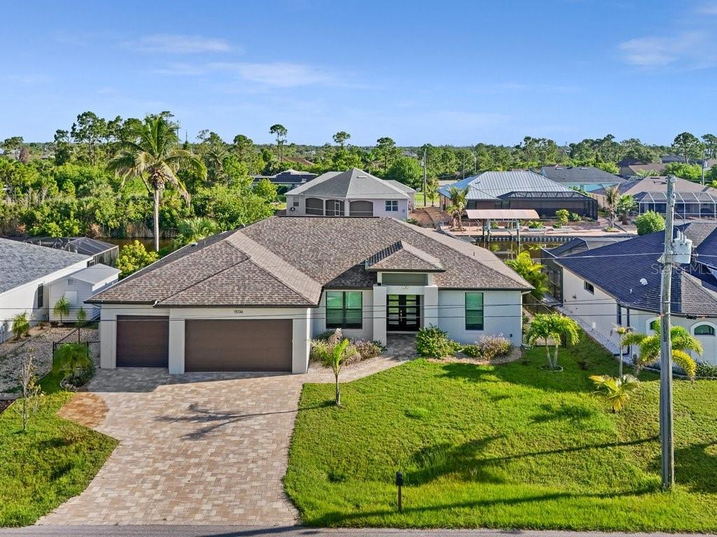 Experience the Salt Life! GULF ACCESS Waterfront Pool Home with HardScape Seawall and access to over fifty miles of navigable waterways in the community South Gulf Cove! This 2021 Built Coastal Inspired Waterfront Pool home features an Open Concept SPLIT 3-BEDROOM plan PLUS Home Office with French Doors and a 3 Car Garage. You'll never be bored of the waterfront lifestyle, with fishing, kayaking, boating, and more right from your own backyard. And when you just need to relax and unwind, the SPARKLING BLUE HEATED POOL with SUNSHELF, paver deck and screen enclosure overlooking the natural scenery will help ease your mind. From the moment you arrive, you'll notice the curb appeal and modern flair of this beautiful home. Upon entering the Foyer, the bright and airy main living areas are sure to please. The Great Room with Volume Ceilings, 8' tall HIGH IMPACT Sliding Doors helps create a seamless flow between indoor and outdoor living areas, and the Den / Home Office with pocketing french doors, high ceilings and propeller fan with light gives a private yet central space with pool and water views. Your Dining Room is SPACIOUS enough to accommodate large gatherings at the table and features Dual Picture Windows and a stylish Orb Chandelier. And the Heart of this Home is the well appointed Kitchen with GRANDE Center Island, pendant lighting, Statuario marble countertops, farmhouse undermount sink, Stainless steel appliances, 42" CUSTOM Upper Cabinets with undermount lighting, subway tile backsplash, modern pulls and closet pantry. On one side, the Primary En-Suite offers lots of natural light with a large picture window and transom for privacy, a generous Walk In Closet, Spa-like Bath with DUAL vanities, fully tiled shower with listello, large mirrors and beautiful granite countertops and backsplash. On the other side of the home, both Guest Bedrooms provide a very comfortable retreat, with large closets, propeller style ceiling fans, and a Shared Hall Bath with tub and tile surround. The 3 Car Garage features 8' overhead doors with two 24' deep bays, finished walls, epoxy floor, pull down stairs to attic access, service door to exterior, and direct access to the Laundry Room with washer/dryer hookups, window, sink and upper cabinetry. Other features include High Impact Hurricane Windows and Doors, 8' Double Entryway doors, Luxury Vinyl Plank flooring, 5 1/4 Baseboard, floor outlet in Great Room, tile flooring in baths, concrete decorative wall adjacent to garage to conceal outdoor trash bins, exterior hose bibs, generator hookup, irrigation system with pump fed from the canal, tropical landscaping including a fruit-bearing Papaya Tree, and more! This is YOUR opportunity to own a Boater's Paradise. You will not want to miss this ~ call today for your private showing.