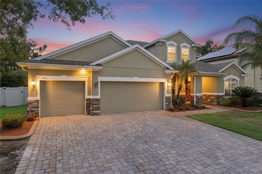 Welcome to 1266 Calypso Way, an impressive pool home located in the desirable Hammock Reserve community of Oviedo. Built in 2012, this spacious residence offers approximately 3,739 square feet with 5 bedrooms, 4 bathrooms, and a dedicated private office, thoughtfully designed for both comfortable everyday living and effortless entertaining. Inside, you’ll find expansive living spaces filled with natural light, including formal living and dining rooms ideal for hosting larger gatherings. The gourmet kitchen is the heart of the home, featuring beautiful 42” cabinetry, granite countertops, a center island, stainless steel appliances, a walk-in pantry, butler’s pantry, and a spacious casual dining area, all seamlessly opening to the family room for easy connection and flow. A generously sized laundry room just off the kitchen offers additional cabinetry and counter space for added convenience. The first-floor owner’s suite provides a private retreat, complete with a large walk-in closet and an ensuite bath featuring dual vanities, a relaxing garden tub, and an oversized walk-in shower. Upstairs, a spacious bonus room with a full bath, adjacent fifth bedroom, and an impressive wet bar with granite countertops and beverage cooler creates the perfect setup for a teen suite, guest retreat, media room, or multigenerational living. Additional interior highlights include engineered wood flooring throughout the home, including the staircase, a whole-home speaker system including the pool area, ceiling fans, low-E double-pane windows, and thoughtful upgrades throughout. Step outside and enjoy Florida living at its finest with a large screen-enclosed private saltwater pool, expansive paver pool deck, and lushly landscaped backyard with no rear neighbors, creating the perfect setting for relaxing or entertaining year-round. Additional exterior features include a paver driveway, gutters, oversized 3-car garage, and whole-home water softener system. Perfectly positioned in one of Oviedo’s most sought-after communities, this exceptional home offers convenient access to Oviedo on the Park, where residents enjoy popular restaurants, boutique shopping, seasonal events, the Oviedo Cultural Center, outdoor concerts, and the Center Lake Park waterfront promenade. Outdoor enthusiasts will also appreciate being just minutes from Black Hammock Wilderness Area, known for its scenic lakefront dining, airboat adventures, boating, fishing, and access to the natural beauty of Lake Jesup. Combined with top-rated Seminole County schools, nearby parks, shopping, dining, and major commuter routes, this home delivers the ideal blend of luxury, lifestyle, and location.