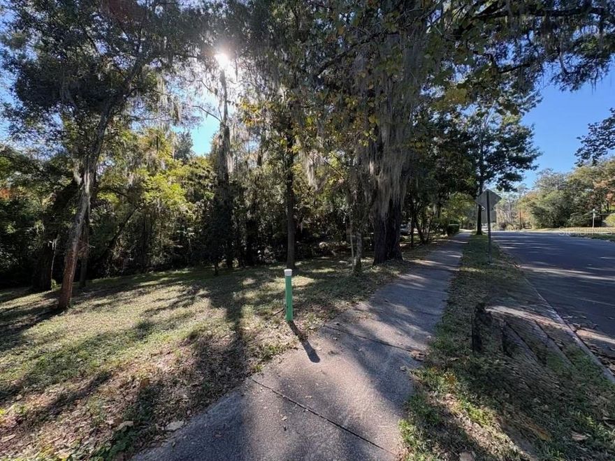 Discover the perfect canvas for your dream home on this rare .31-acre lot nestled in one of Gainesville's most desirable neighborhoods with mid-century modern historic appeal. Located just minutes, and an easy bike ride, from the University of Florida, UF Health, the VA, and the vibrant downtown area, this prime location offers the best of both worlds: tranquility and convenience. Immerse yourself in a wonderful walking neighborhood with sidewalks, perfect for leisurely strolls and outdoor activities.

This rare gem presents an unparalleled opportunity to design your custom home in a highly sought-after area where vacant lots are few and far between. It is open to any builder, with no home owners association (HOA), and has access to city water, sewer, gas, fiber internet, and other modern telecommunications. The rolling hillside, with approximately 10 feet of slow and steady elevation drop from the northeast to the southwest corners of the lot, offers unique views into a wooded conservation area and is especially well suited to stem wall or post-and-pier foundations, as well as split level or walk-out basement designs. Don't miss your chance to own a piece of Gainesville paradise.