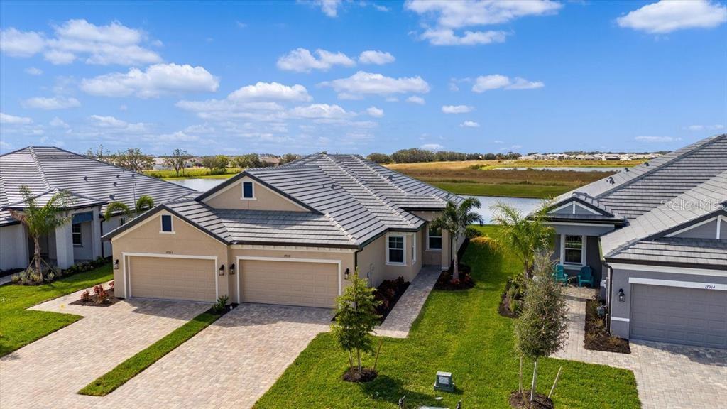 Available from June 4th until July 31st. Rented August 1-February 1 2026. Welcome Home to your new luxury villa located in the stunning Sweetwater subdivision in the extremely popular Lakewood Ranch community. Fully furnished and ready for only your suitcase, this stunning property is. Boasting 1452 square feet of open living space, split bedrooms with a sizeable bonus room, this spacious villa has everything you want to make this house your home. Upon entering your private entrance, you will notice the open living space with the bonus room opening to double doors. This could be your office, a quest room or simply a recreation room. The beautiful kitchen has tall cabinets with ample storage. The breakfast bar is excellent for entertaining. The closet pantry is sizable with additional storage. The gas range has a griddle addition or taken off will provide 5 burners with a double oven. Beyond the kitchen is your dining/living space completely open and spacious. From the dining is the entry way to the second bedroom and guest bathroom with storage space along the hallway. The 10’ ceilings and 12’ tray ceiling in the living room give the room an additional height to give an even more spacious look. The master bedroom, off of the living room has a king size bed space, walk in closet and a large master en-suite with dual sinks and large walk-in shower and bench space for comfort. The lanai is located with high sliders to the west facing view with stunning sunsets and pond views. What an amazing way to enjoy Florida living. Additionally, the garage has two indoor spaces and additional driveway spaces. Sweetwater is a beautiful gated community located within Lakewood Ranch. The amenities include two large clubhouse facilities available for rent or for resident use, two sizeable gym facilities with state of the art equipment. Two heated pools (excellent for winter and spring time use). Pickleball is quite the popular sport among residents with courts at both amenity center locations. The pool, in the villa location, has a sitting area on the pond with amazing sunset views or just to relax and read a book outdoors. The mail pool has a recreational covered sitting area with a television, outdoor fireplace and gas grill. Sweetwater is just minutes from 4 different Publix locations, shopping and nestled between SR 70 and SR 64. It is also located to some of Florida’s most beautiful beach locations in Anna Maria Island, Sarasota and Siesta Key beaches. SRQ and Tampa International are all within a short drive from the location as well. Make an appointment because your piece of paradise is awaiting.